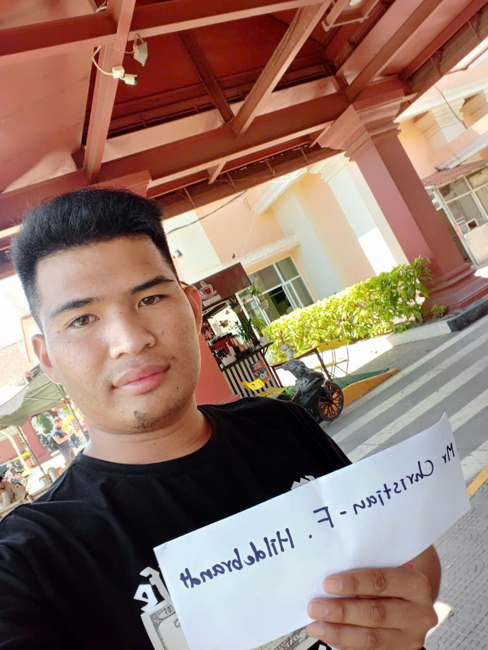 A Vietnam Trails Travel representative holding a welcome sign at the airport to assist travelers with fast-track immigration services