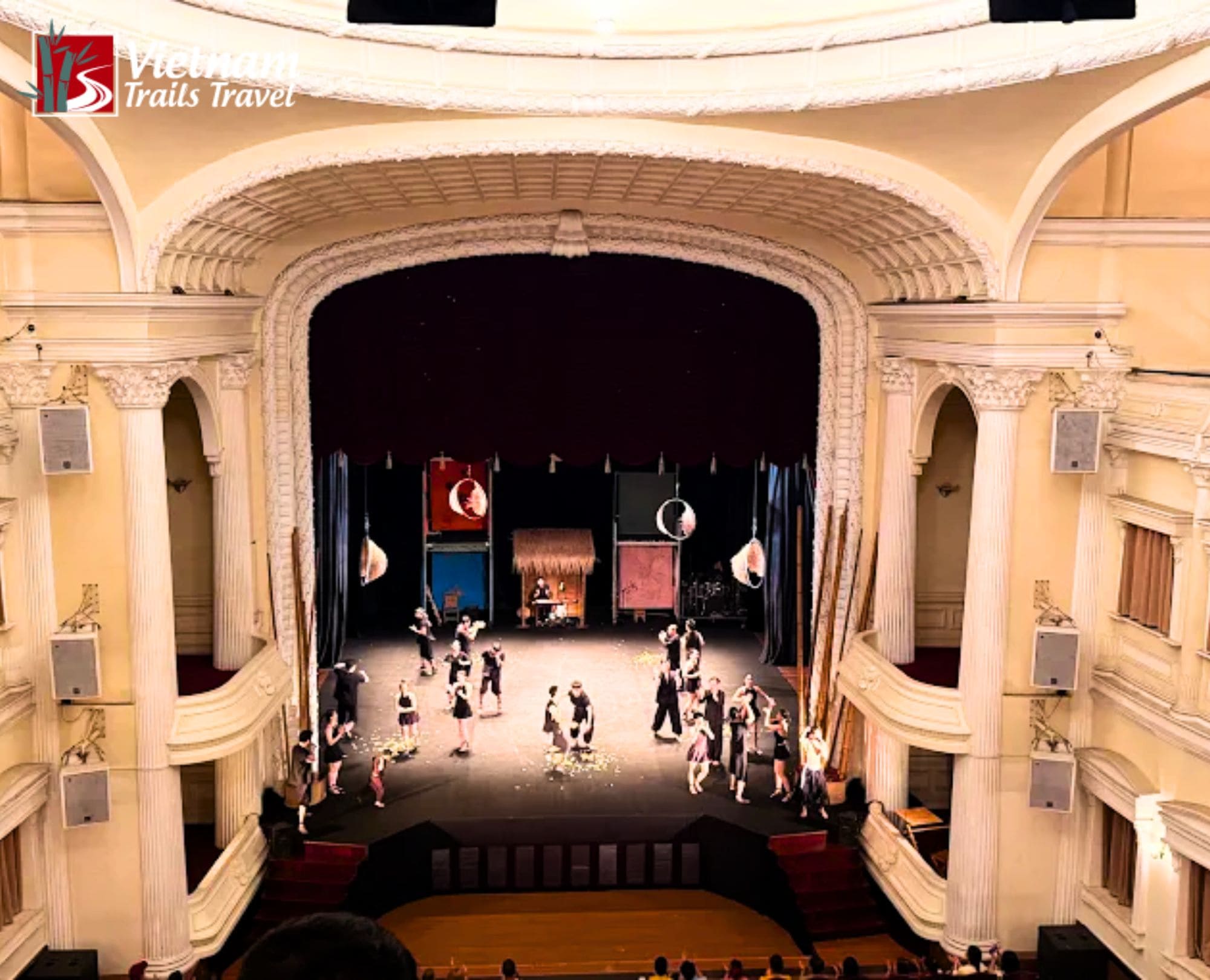 A high-angle view of an A O Show performance on the stage of the Saigon Opera House