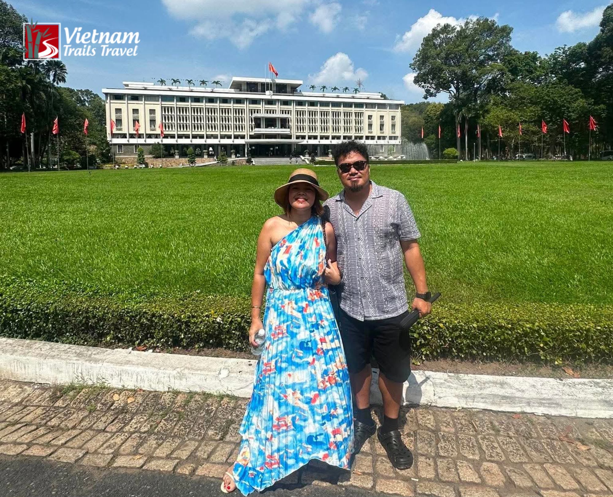 A tourist couple checking in in front of the Independence Palace