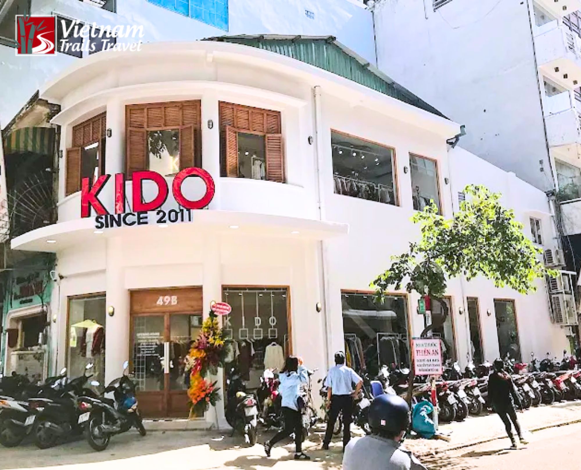 Crowded sidewalks with motorbikes and charming shops, typical of shopping in Saigon