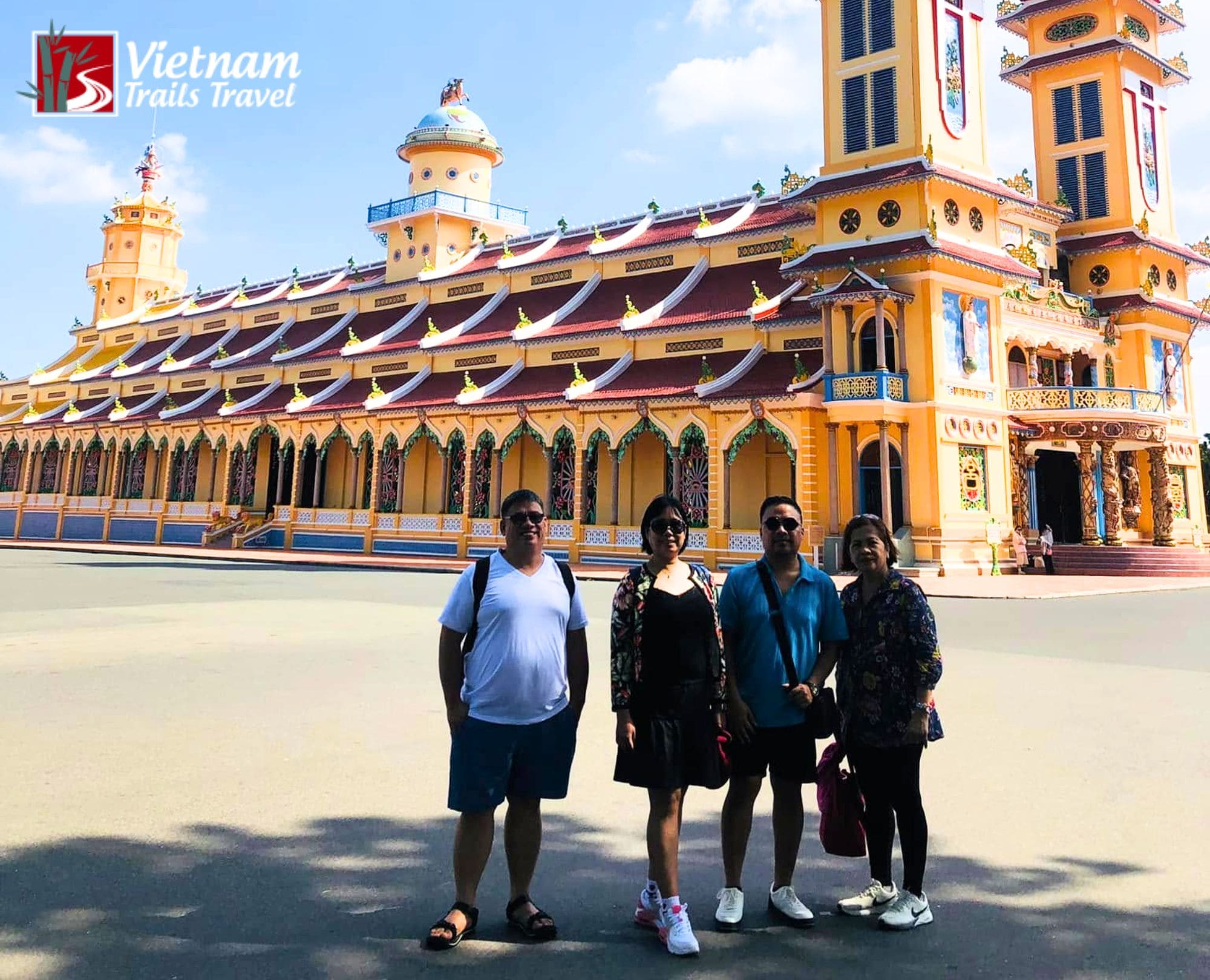 Tourists posing in front of the Cao Dai Holy See temple in Tay Ninh