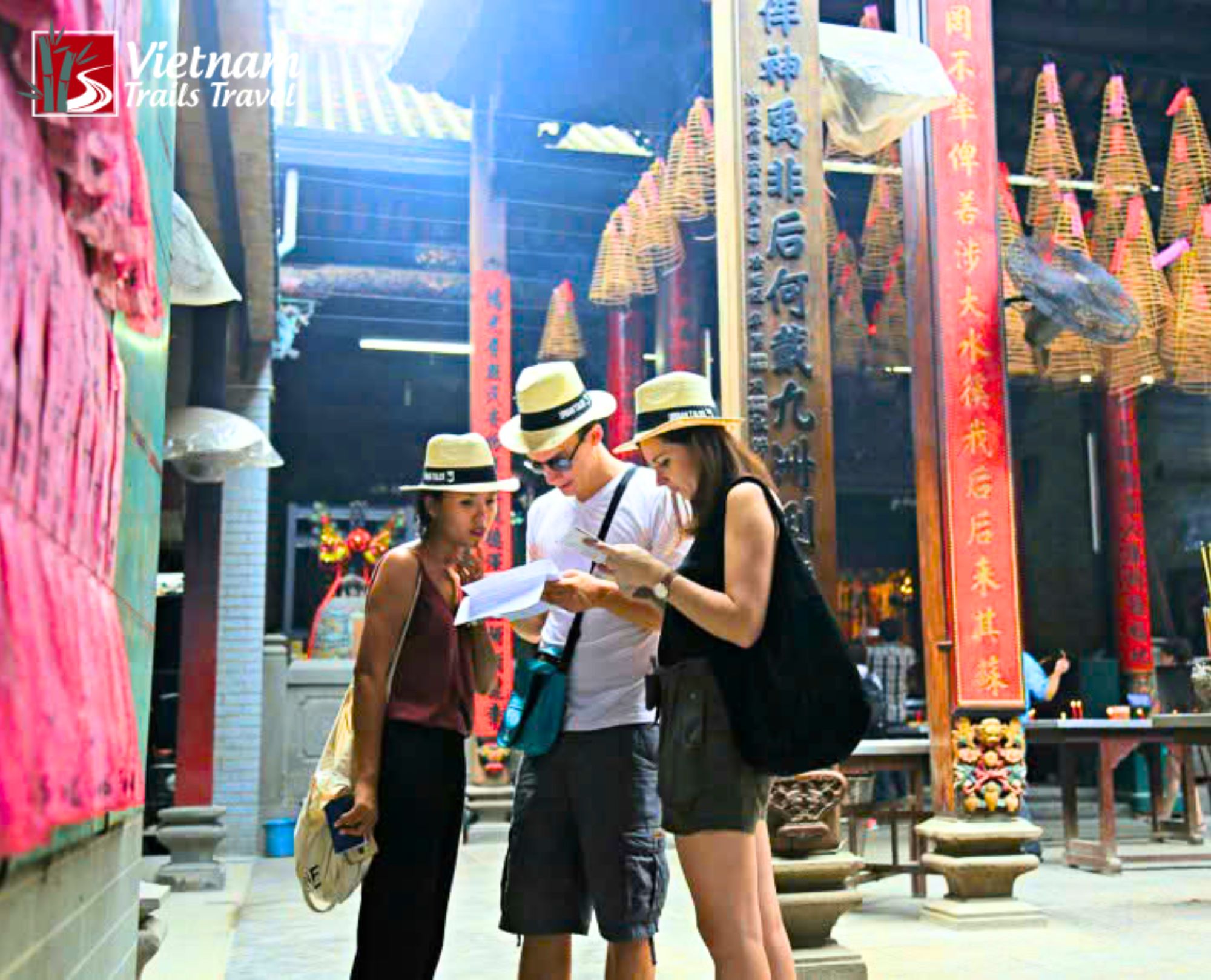Travelers exploring the interior of the Jade Emperor Pagoda in Saigon, a famous Taoist temple known for its ornate architecture and spiritual atmosphere