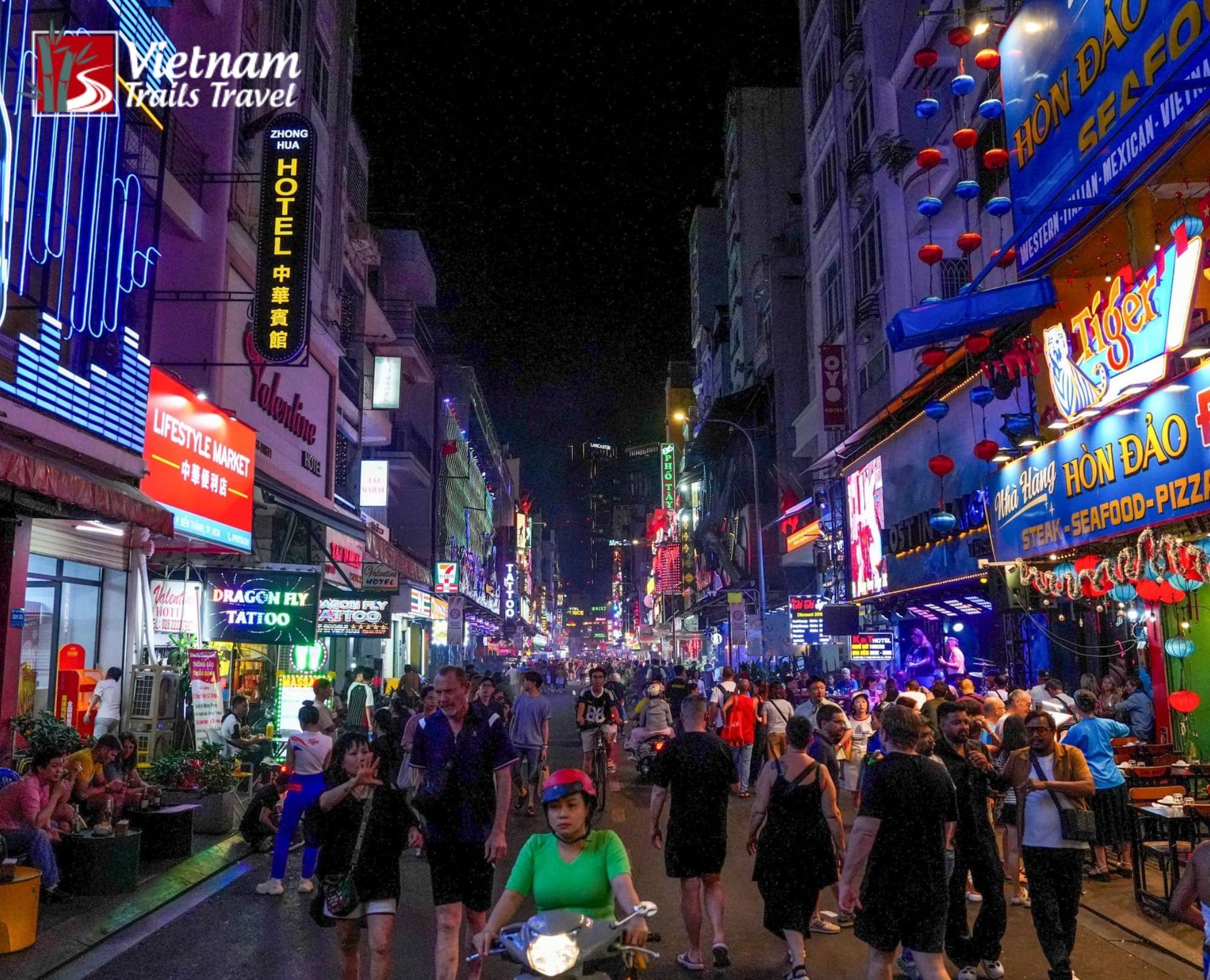 Vibrant nightlife at Bui Vien Walking Street in Saigon with glowing neon signs and busy crowds