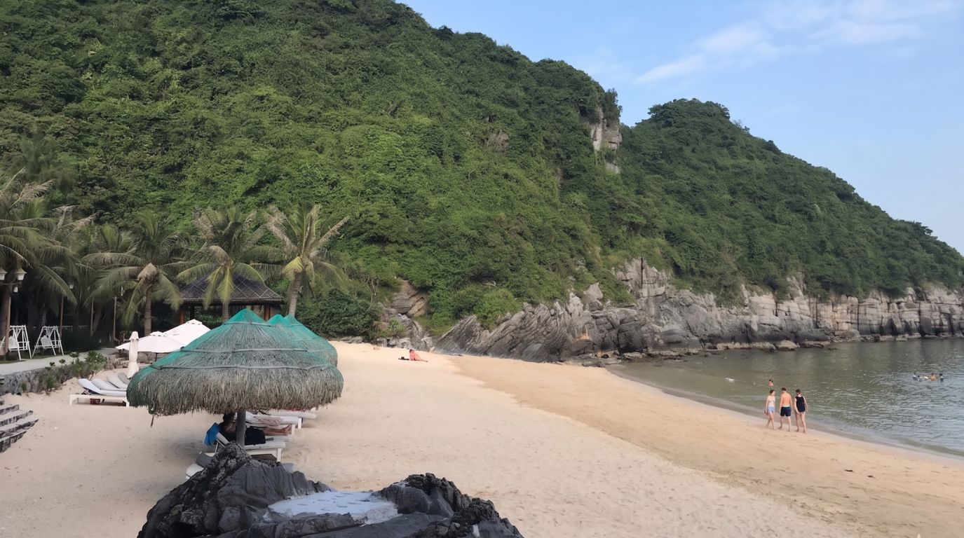 A beautiful Cat Co 2 beach nestled among lush green limestone karsts on Cat Ba Island, featuring thatched umbrellas and calm waters