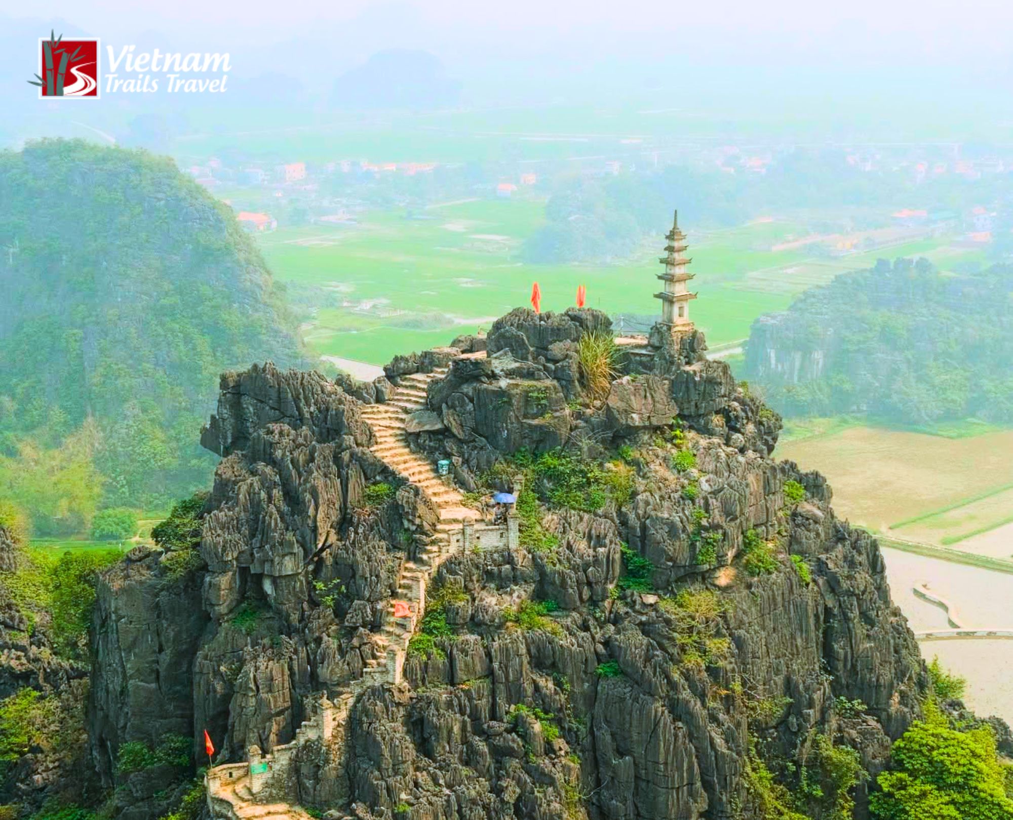 Aerial view of Mua Cave with winding stairs on limestone mountain in Ninh Binh