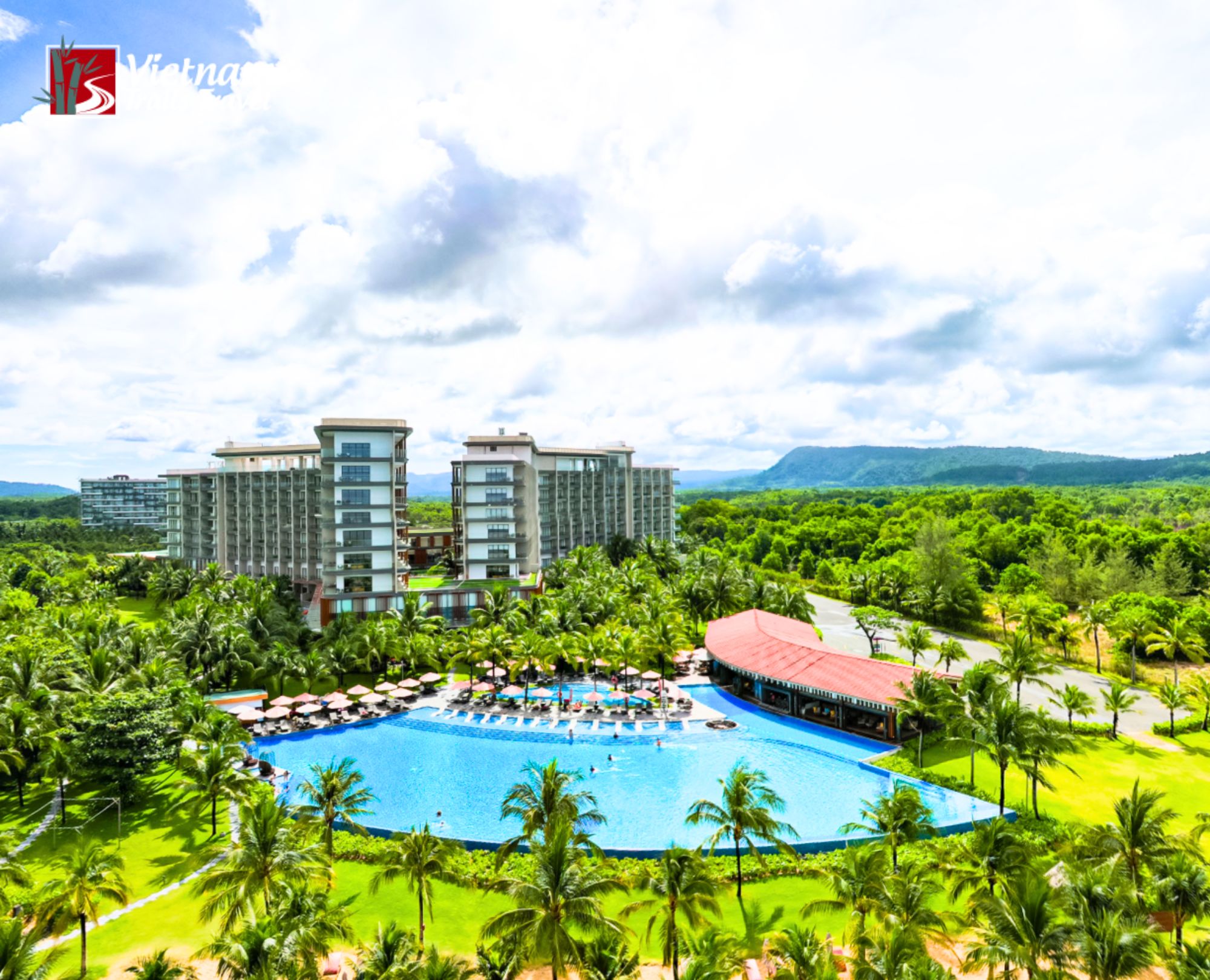 An aerial view of Mövenpick Resort Waverly Phu Quoc reveals a stunning resort complex surrounded by lush tropical greenery