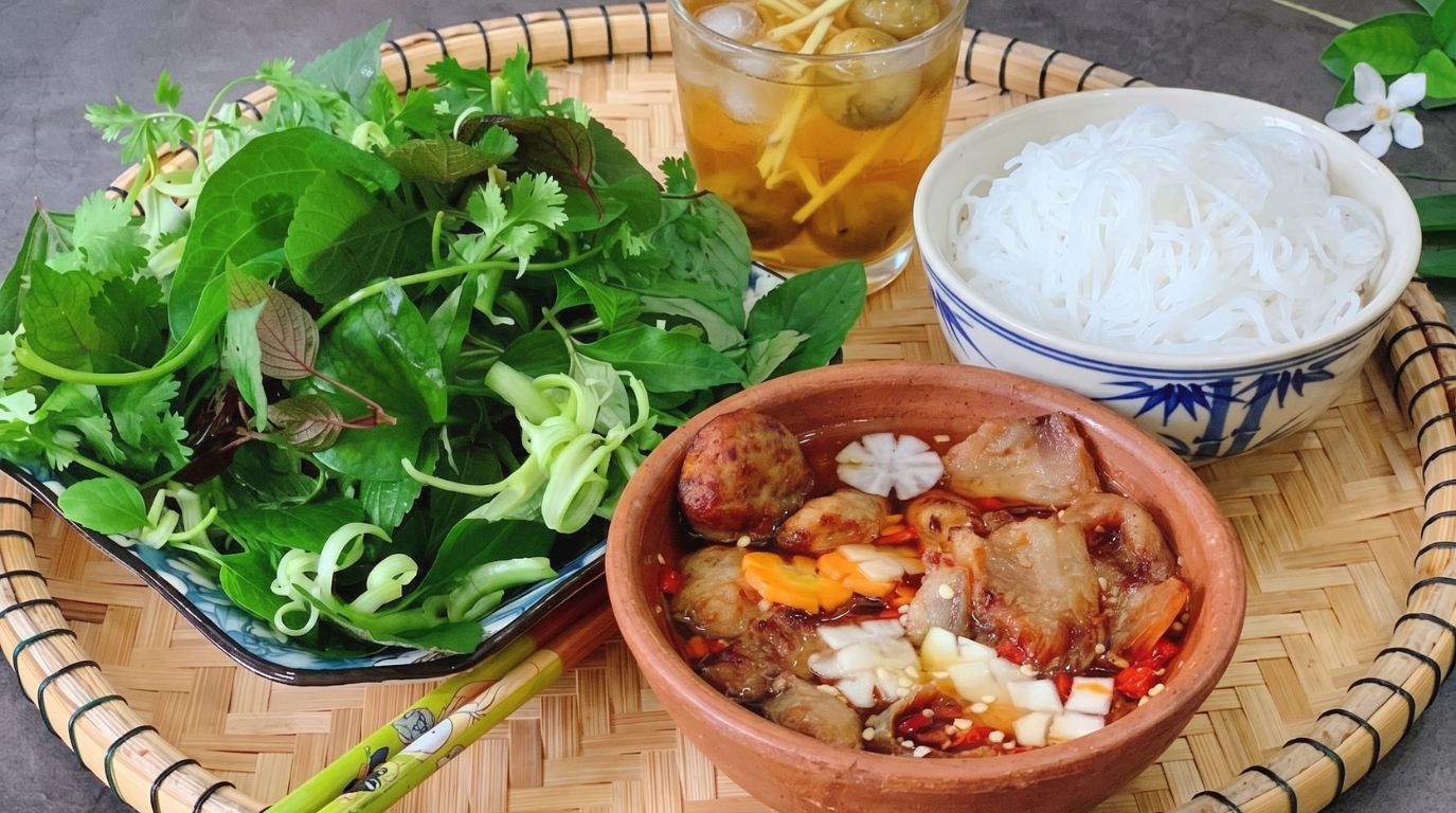 Authentic Vietnamese Bun Cha dish with grilled pork, rice noodles, fresh herbs, and iced tea on a bamboo tray