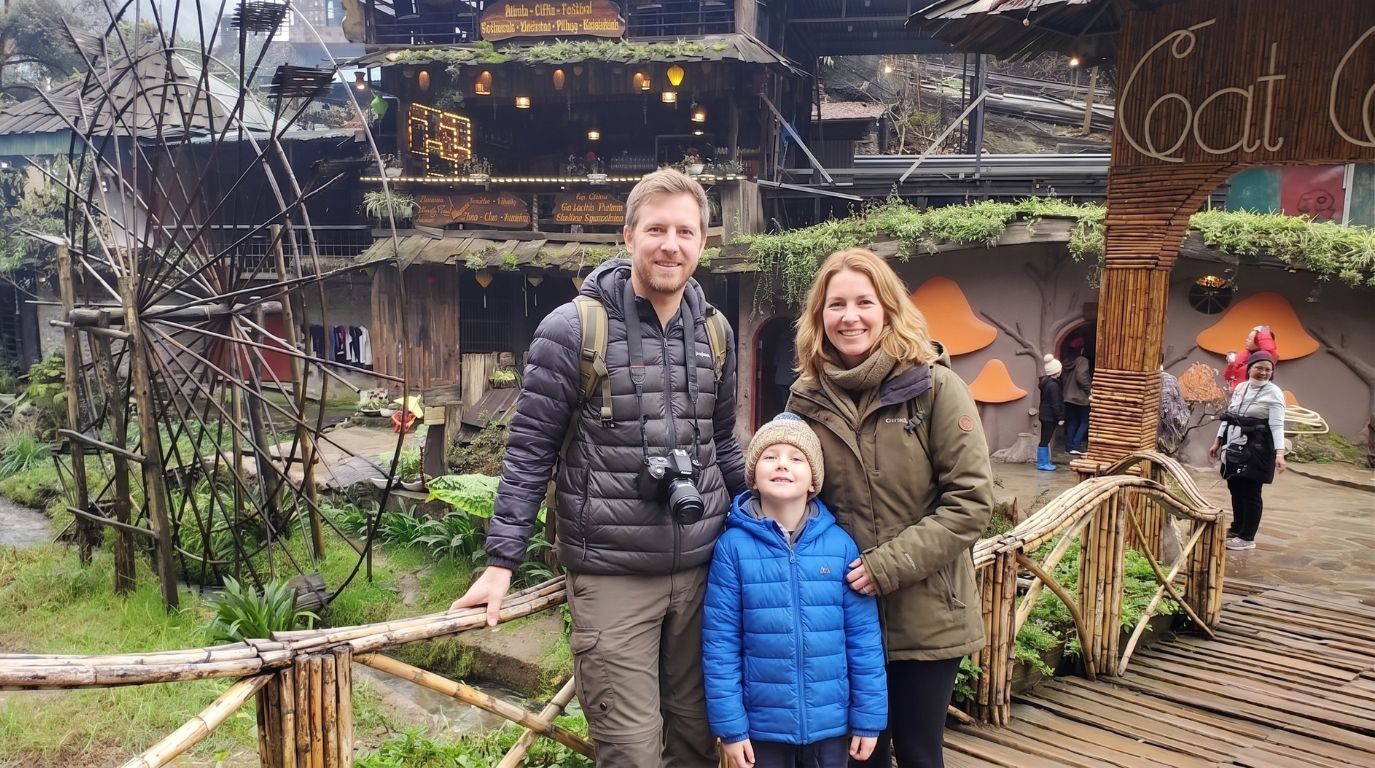 Family enjoying a guided walking tour at Cat Cat Village, a popular cultural tourist attraction in Sapa