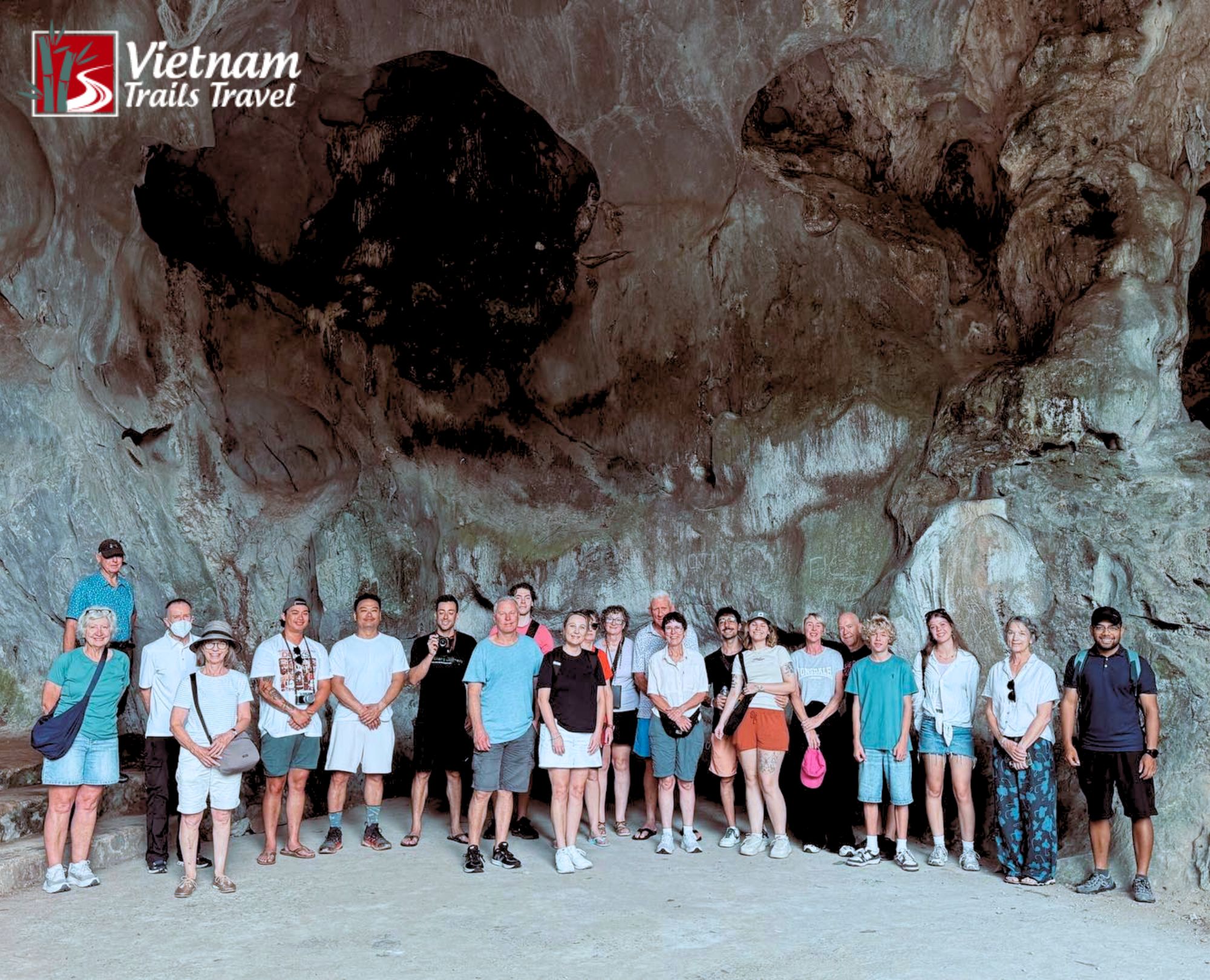 Group of tourists posing for group photo inside Trung Trang Cave