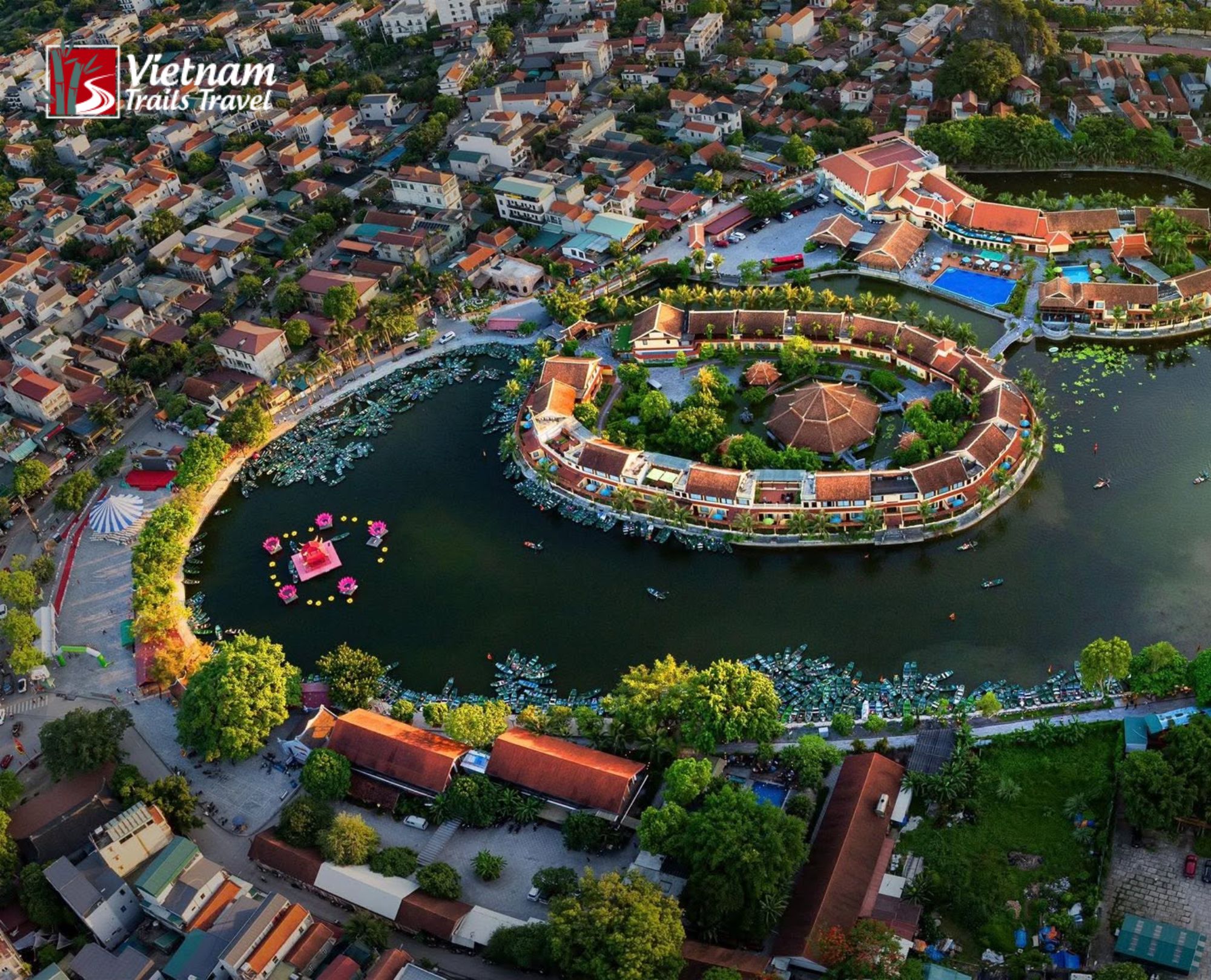 Tam Coc area town built around crescent shaped lake with limestone mountains