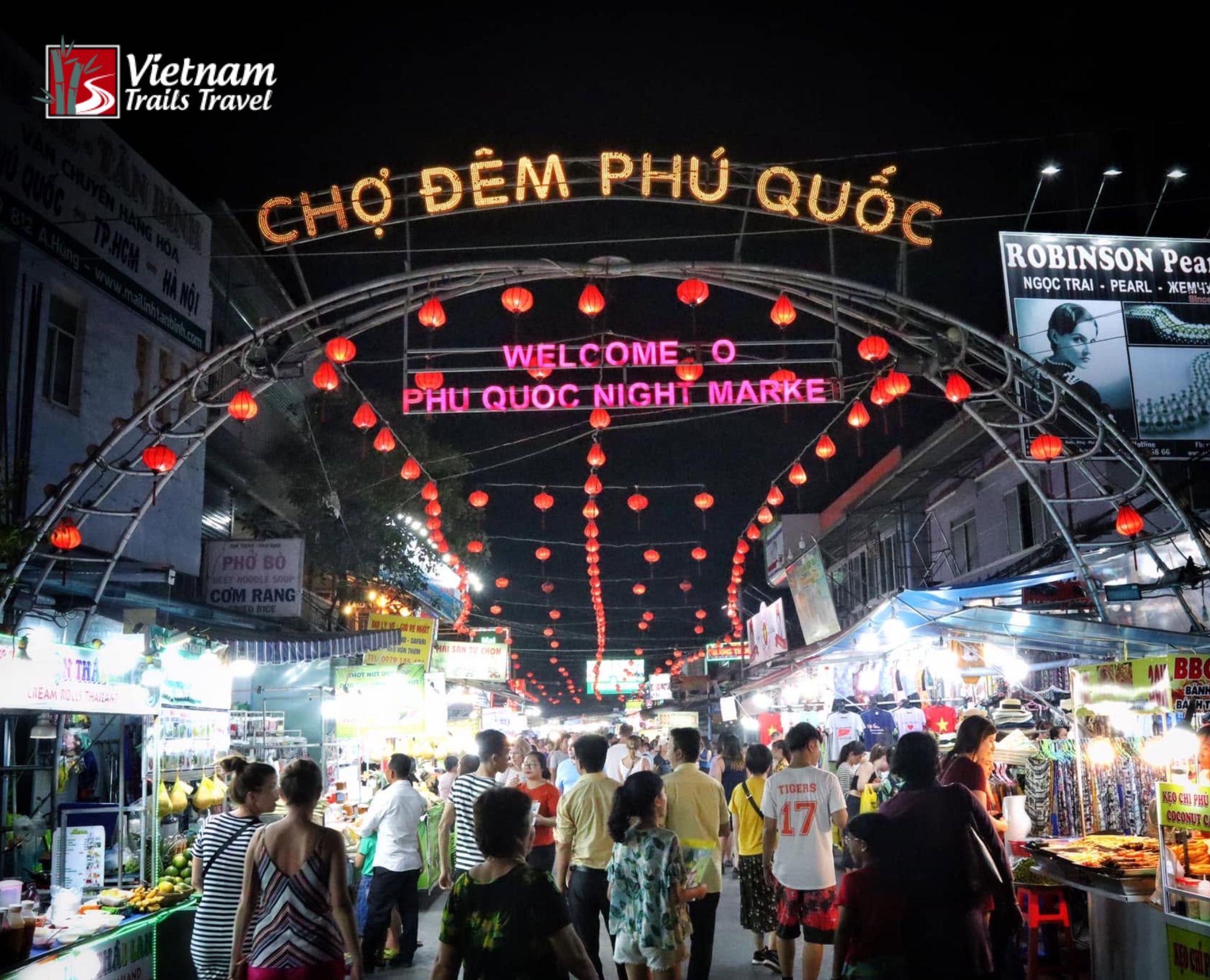 The iconic entrance of Phu Quoc Night Market welcomes visitors with glowing red lanterns and bright lettering