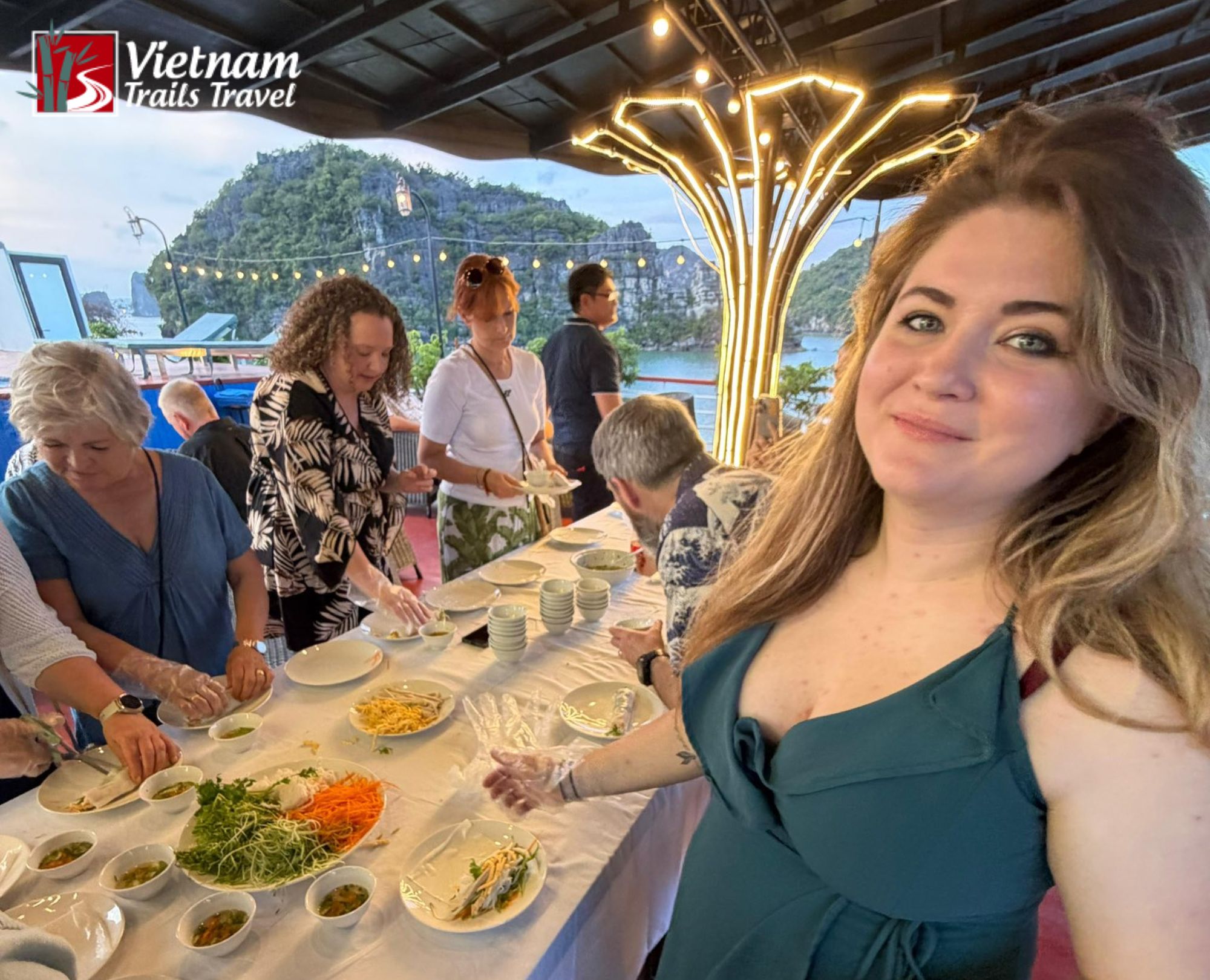 Tourist making spring rolls on a Halong Bay cruise