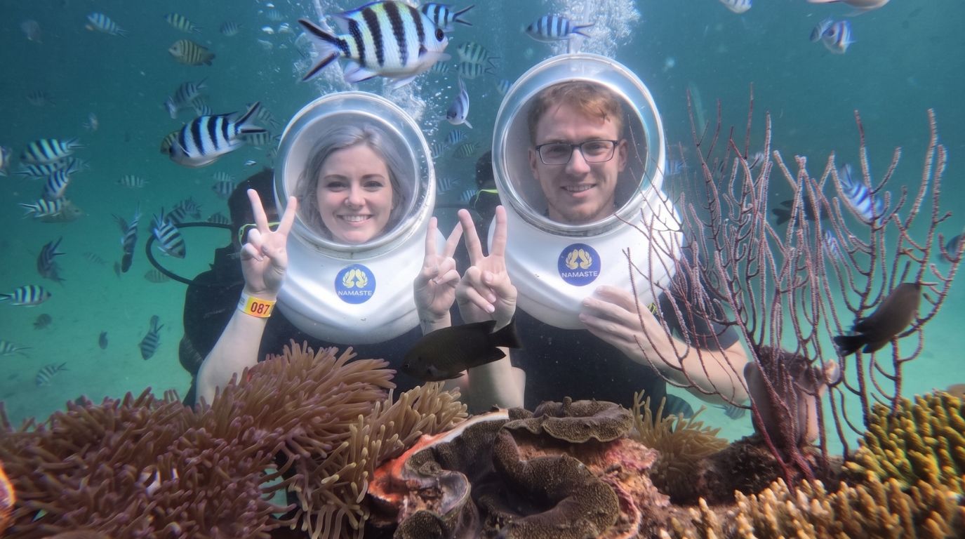Tourists experiencing an underwater sea walking tour among coral reefs at Namaste Coral Park in Phu Quoc