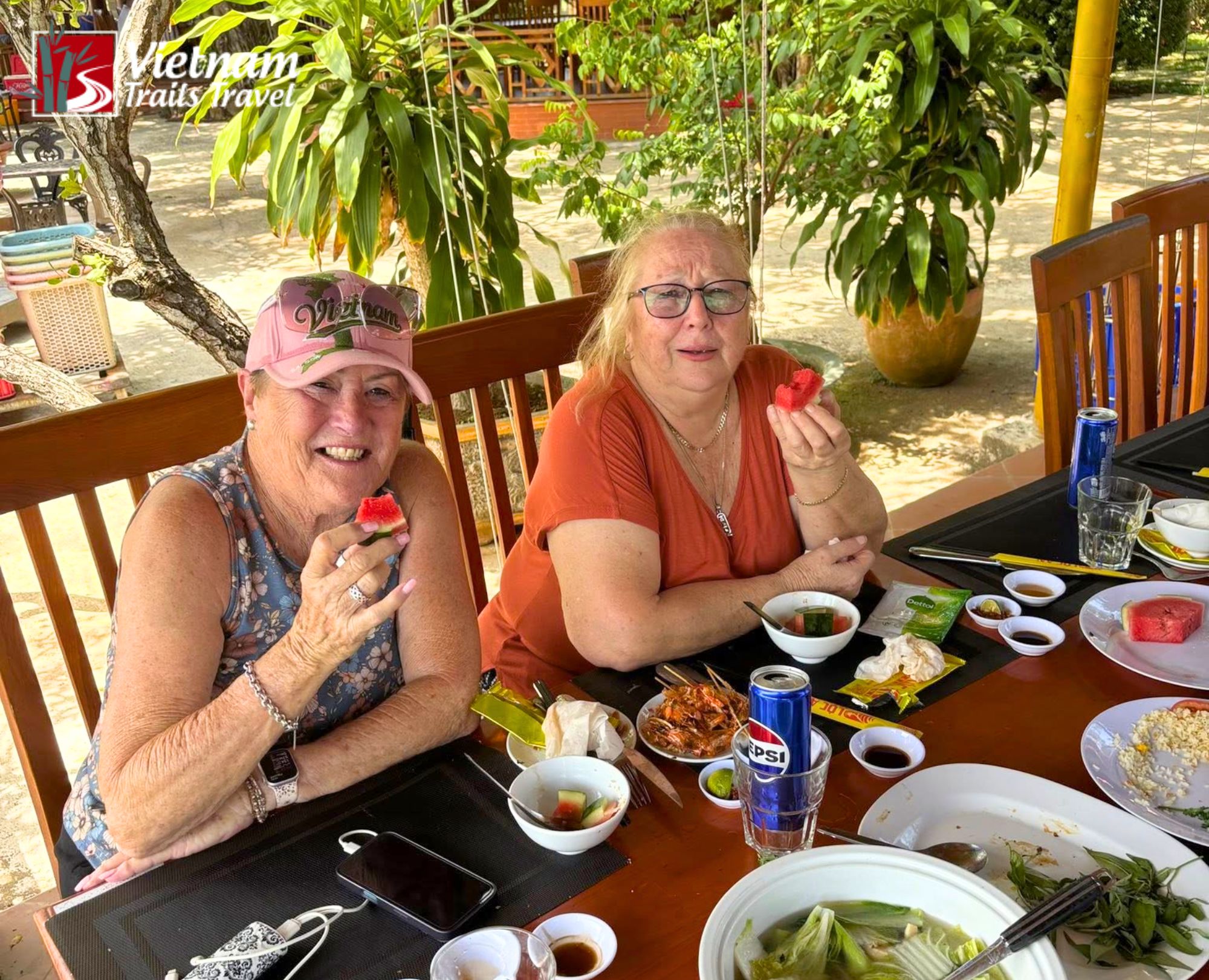 Tourists having lunch with local cuisine and fresh watermelon in Ba Ria, Vietnam