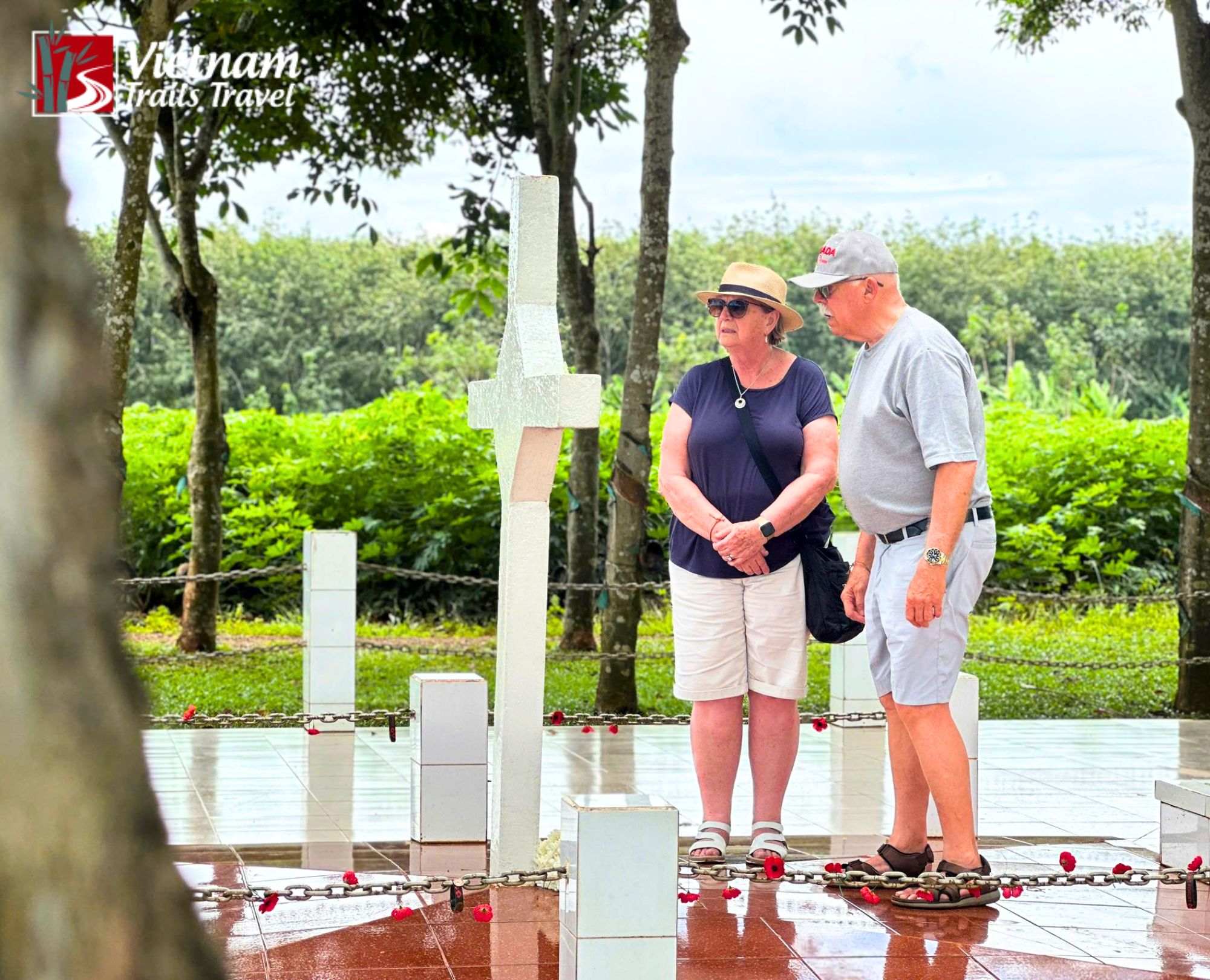 Tourists visiting the Long Tan Cross memorial site on a historical battlefield tour in Vietnam