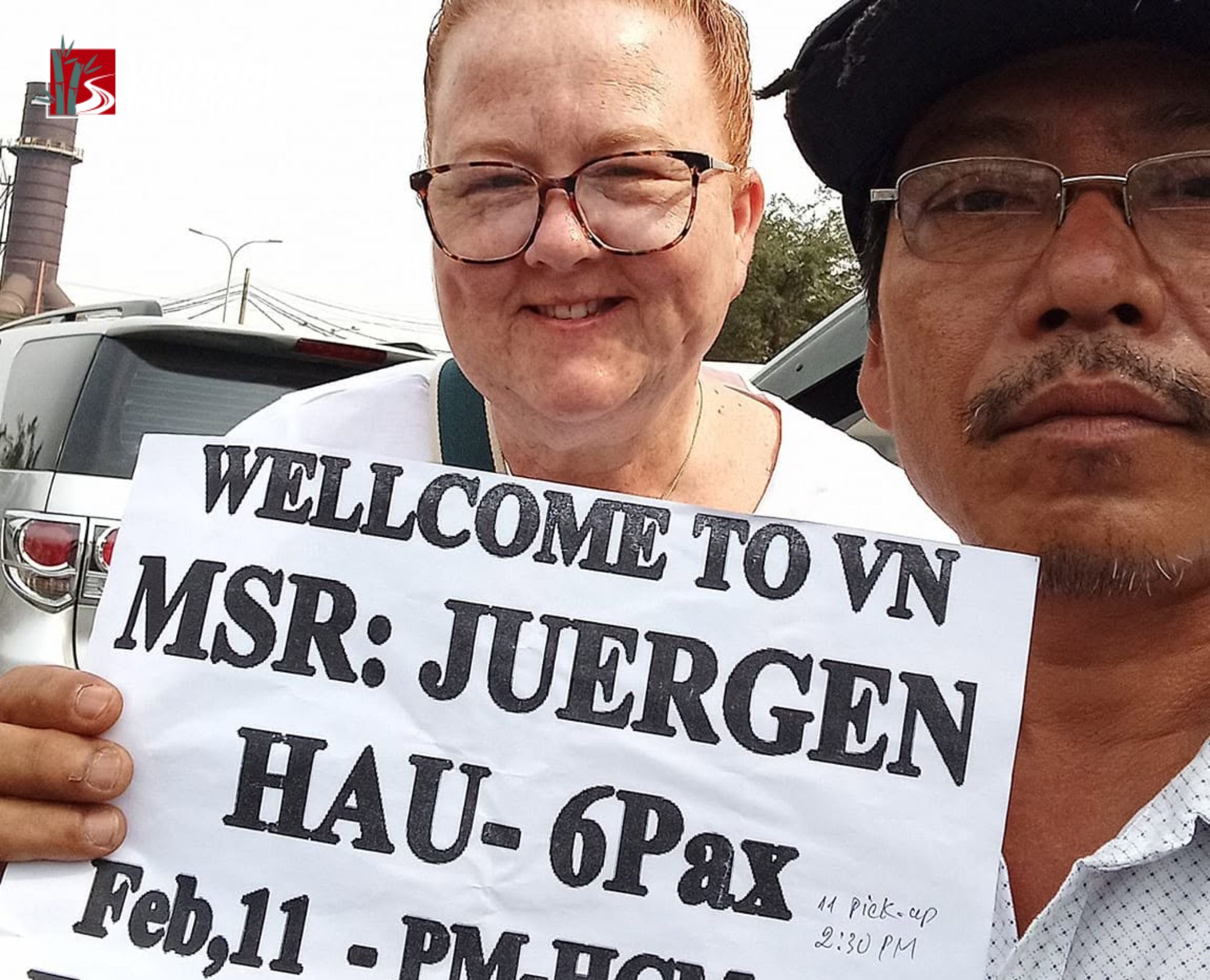 A Vietnamese tour guide meets guests at Phu My Port holding a name sign