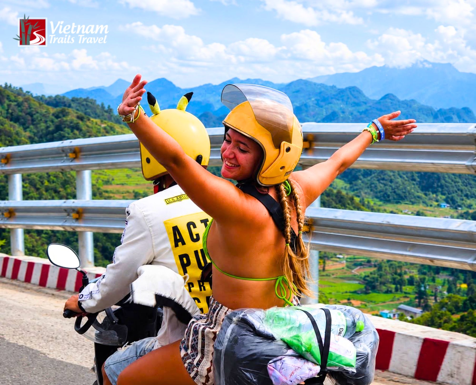 Adventurous motorbike duo cruising along a mountain road in Hà Giang