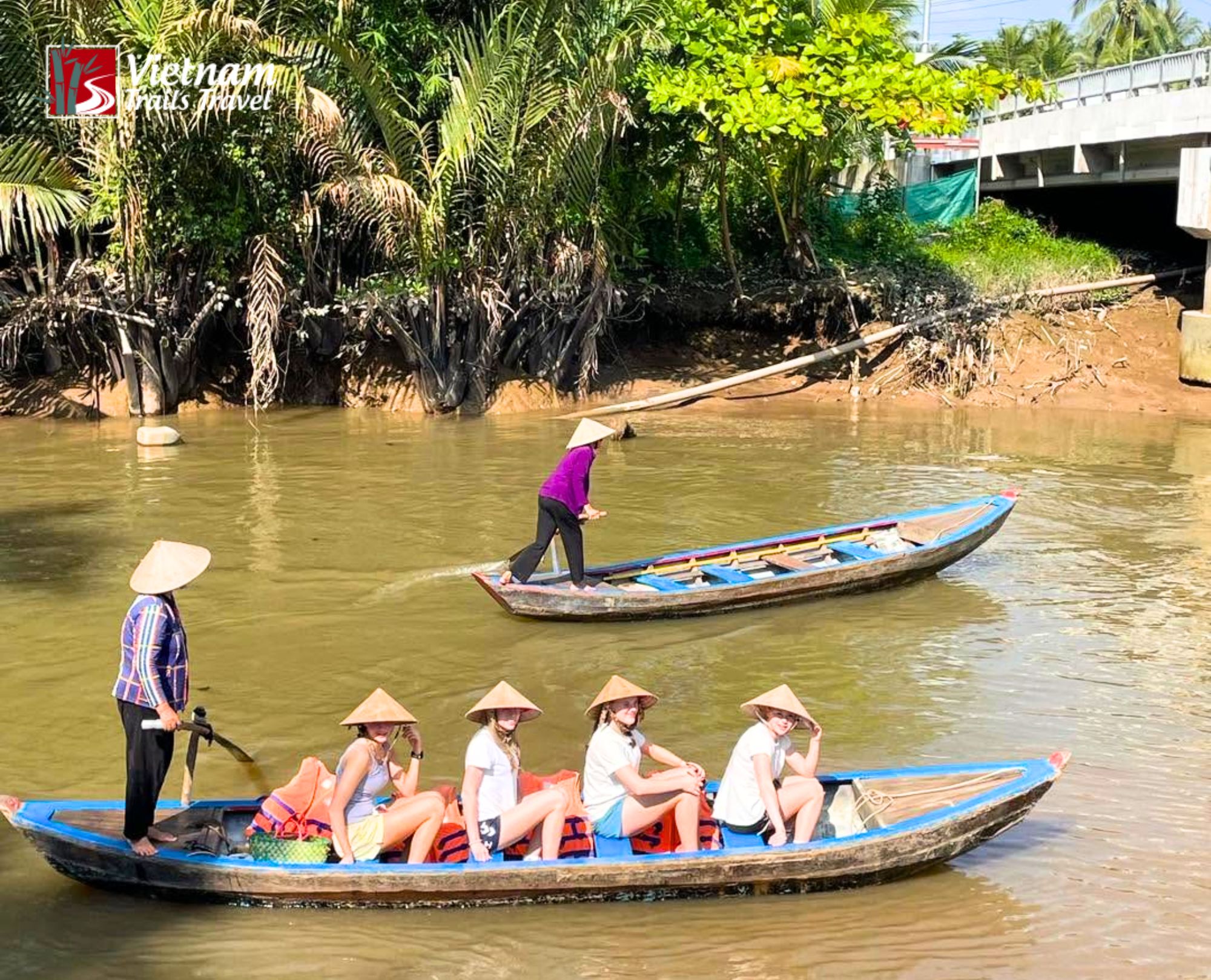 Traditional Vietnamese sampan carrying tourists on a Mekong Delta tour from Phu My Port