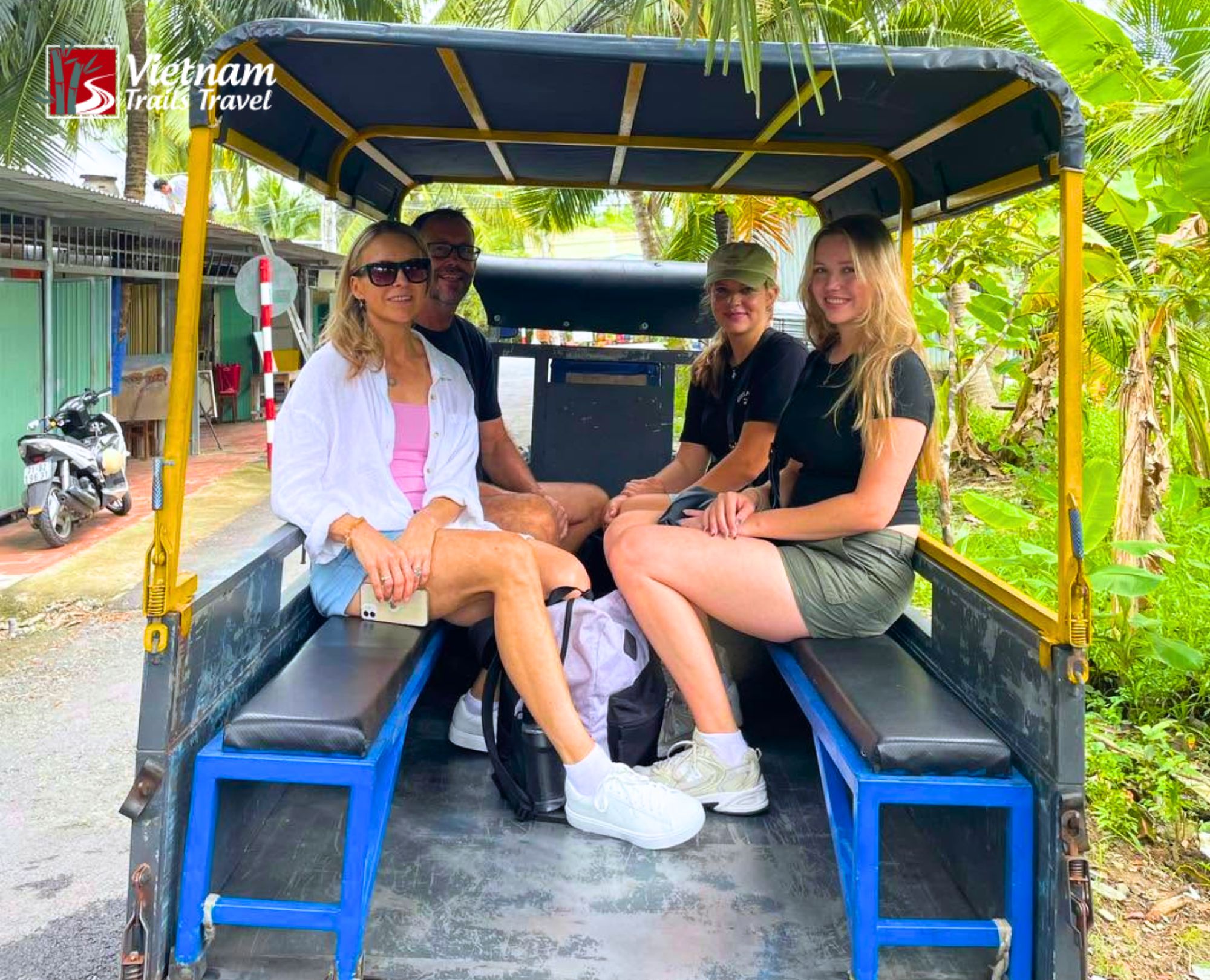Travelers seated in a horse-drawn carriage exploring a local village