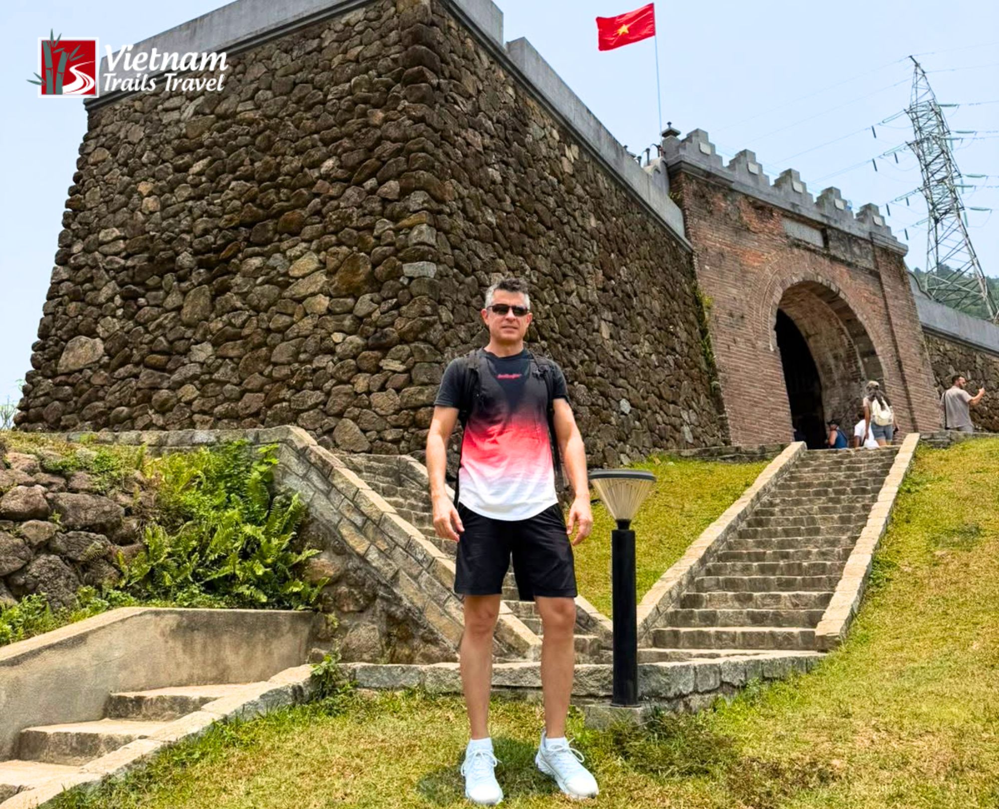 A male tourist takes a photo at Hai Van Gate while on his way