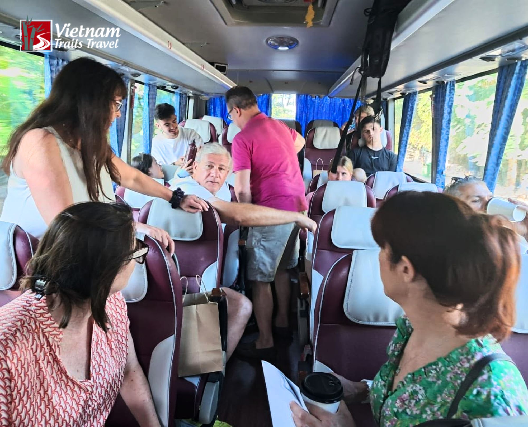 On time return to Chan May Port after Ba Na Hills shore excursion with happy travelers on bus