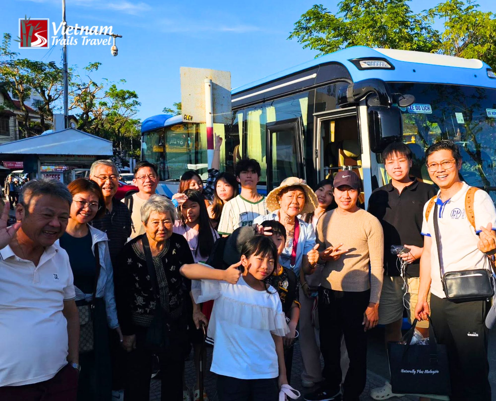 Tour guide picking up group outside Chan May Port with bus transportation