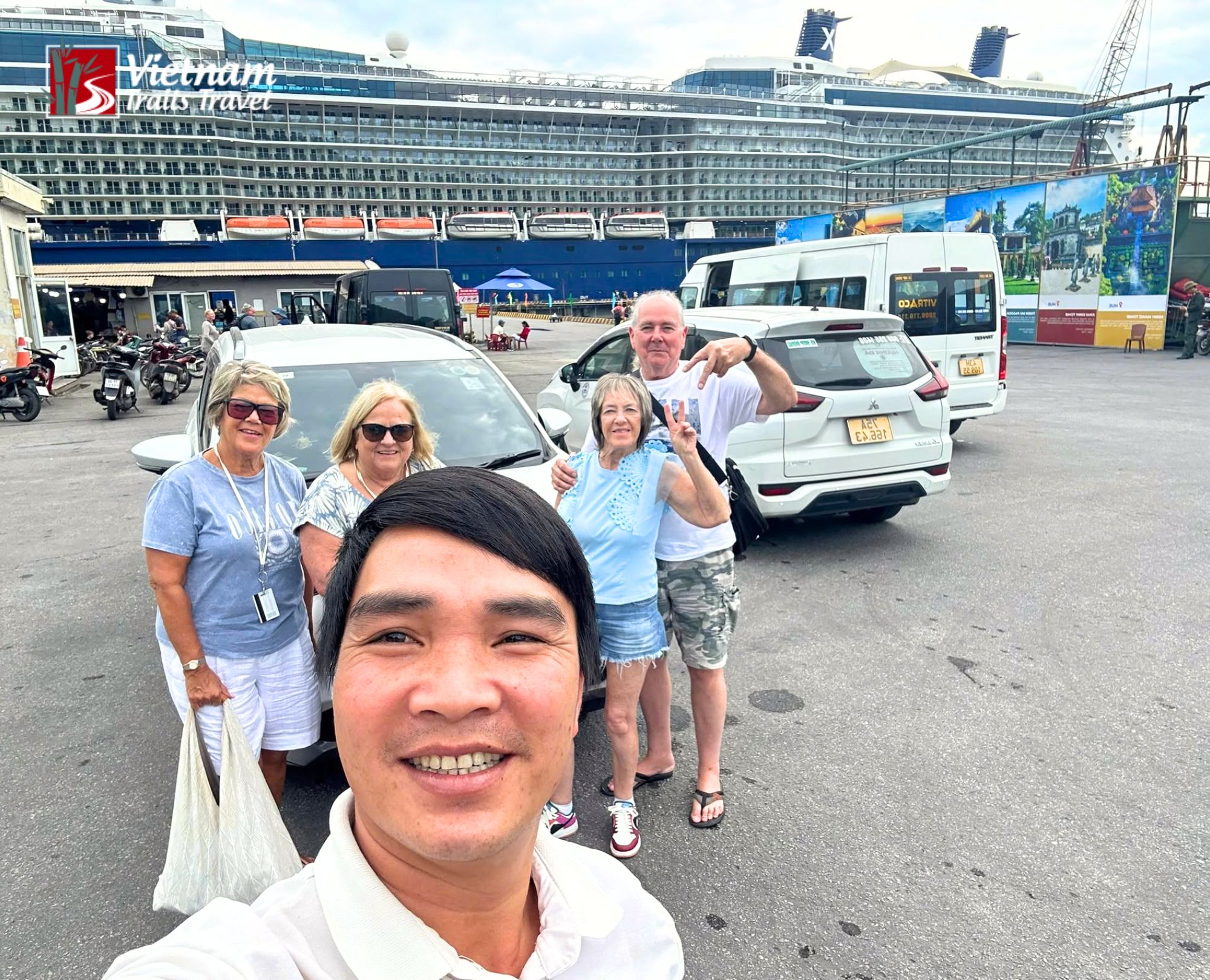 Tour guide welcoming guests inside Chan May Port for Ba Na Hills private tour with cruise ship in background