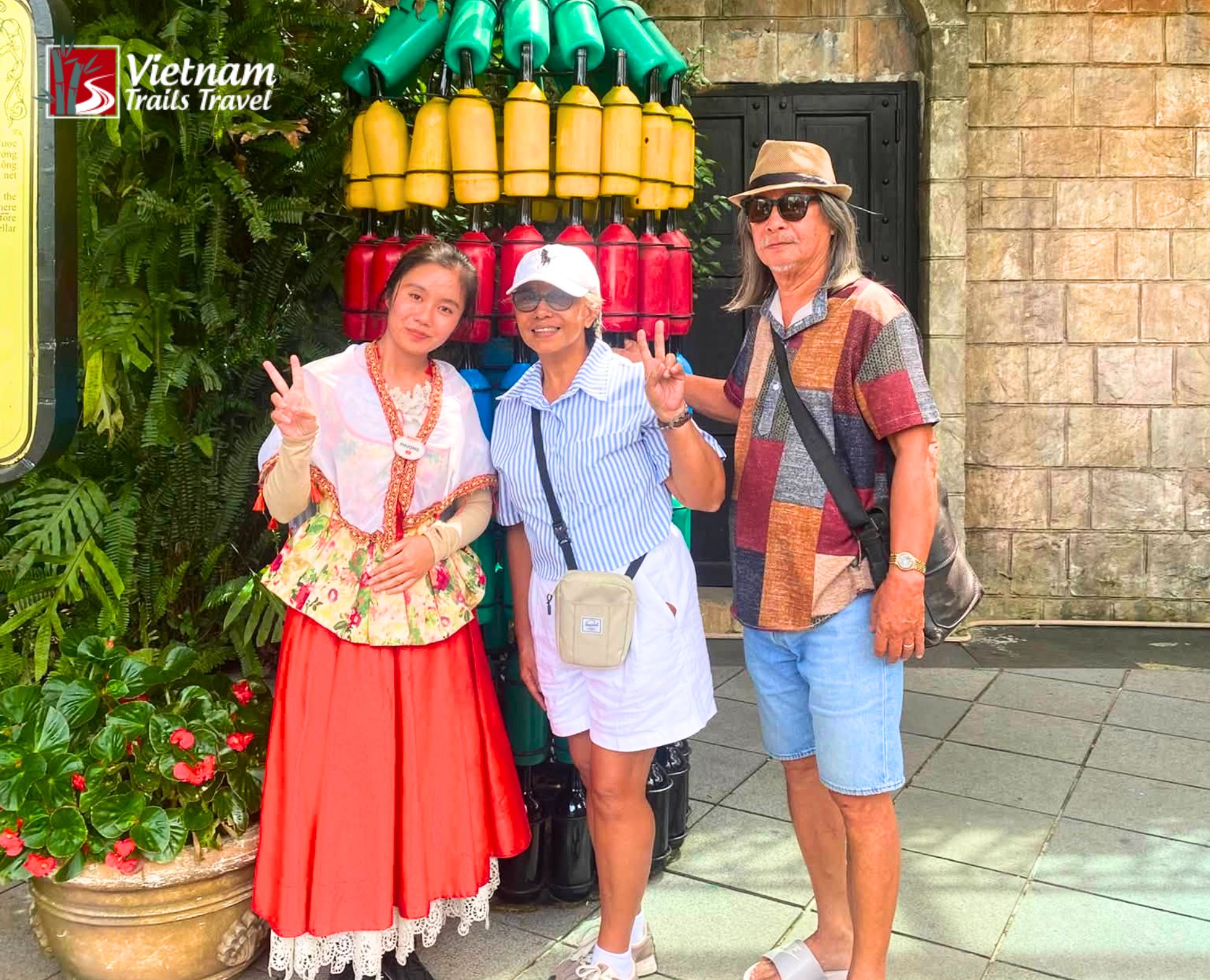 Two guests pose for a photo with staff members before entering Debay Wine Cellar