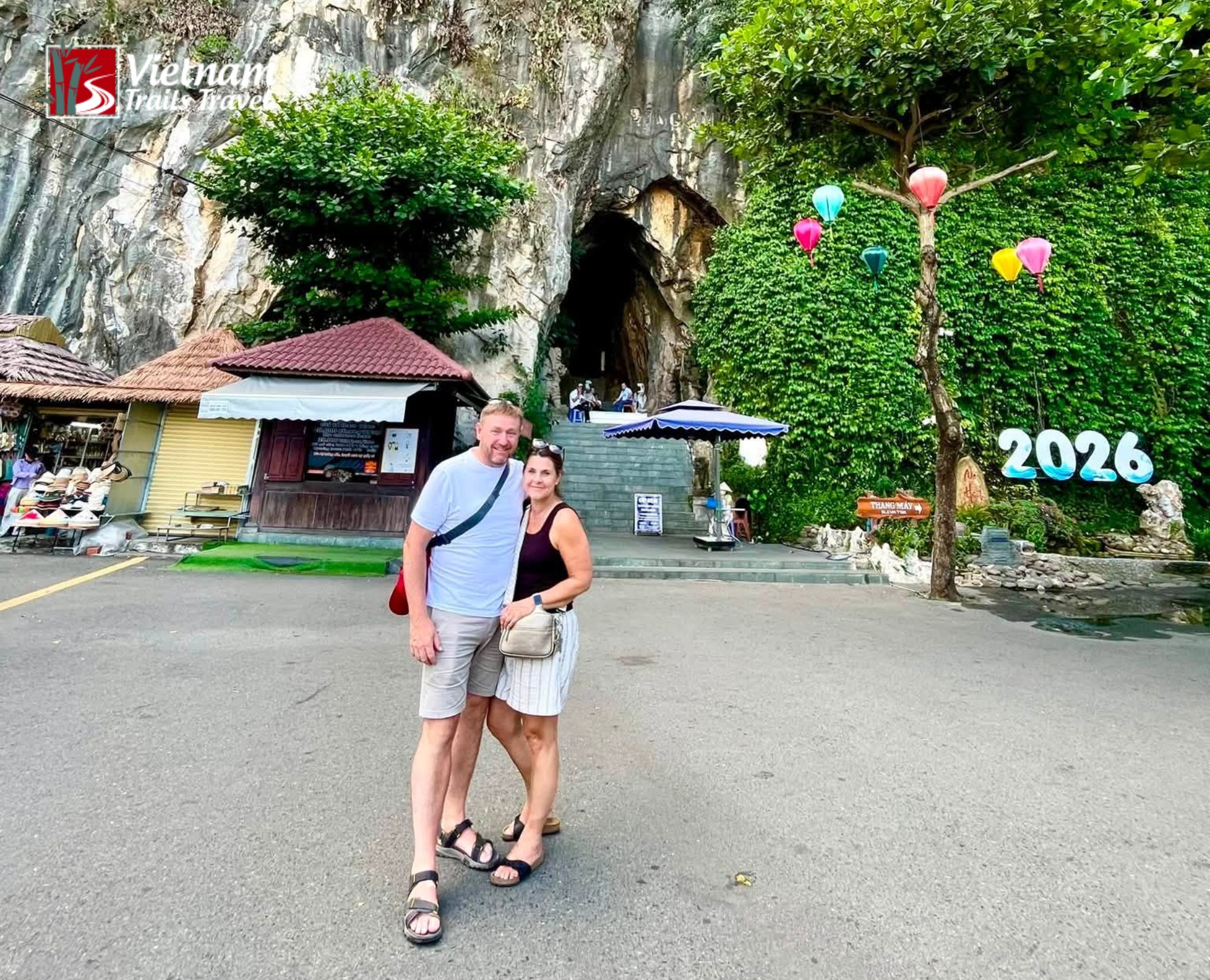 Visitors posing for a photo at Marble Mountains Vietnam with the natural cave entrance