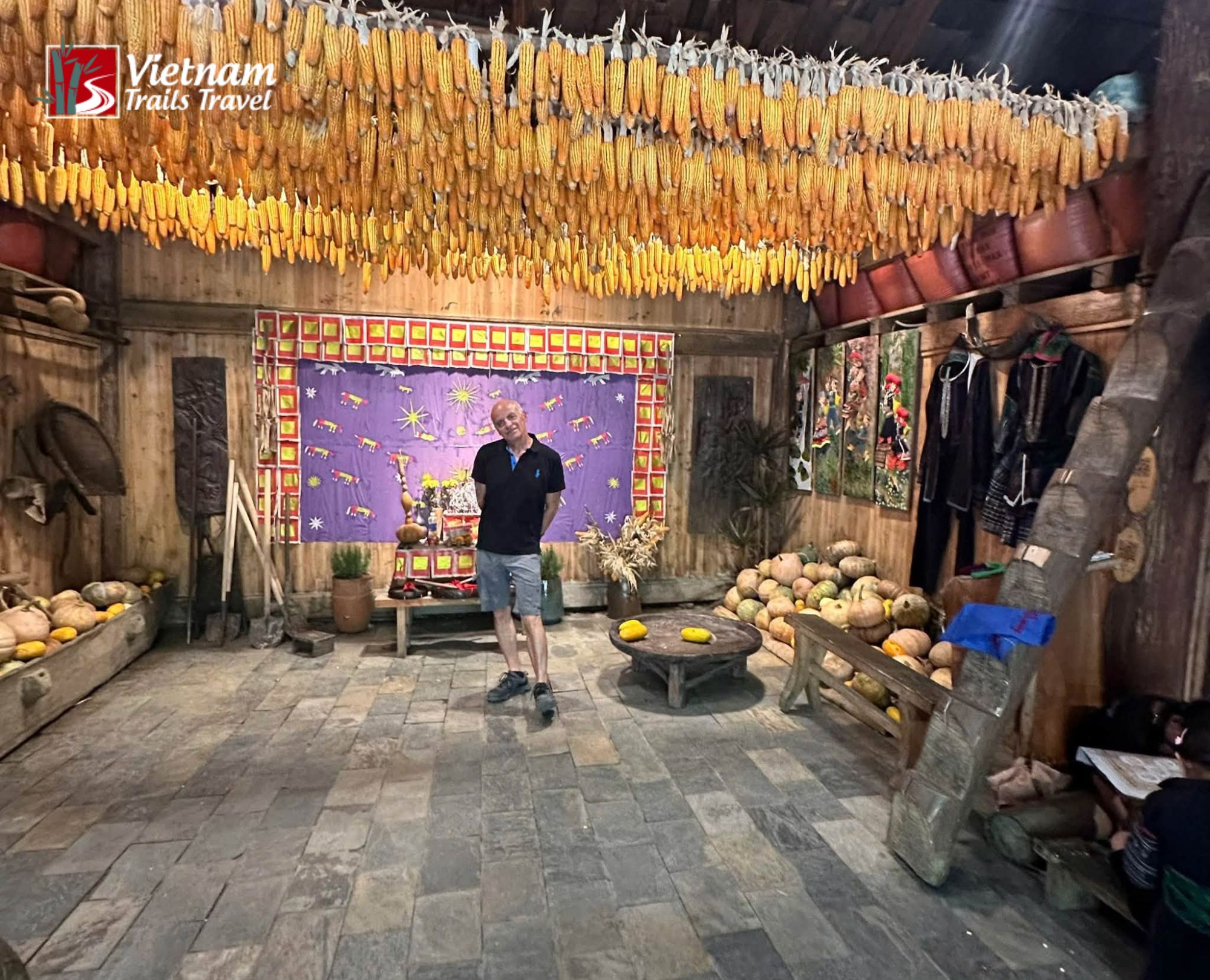 A tourist exploring the interior layout and traditional architecture of a dzao ethnic minority house