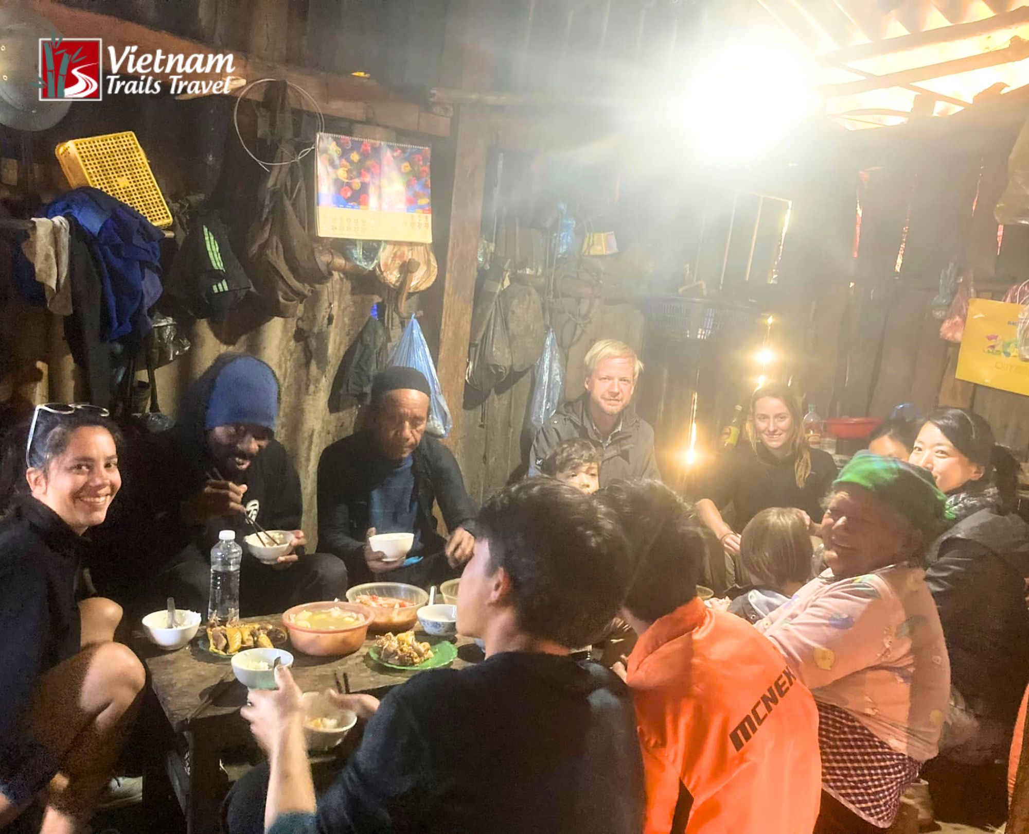 Tour participants experiencing authentic minority culture by eating a home cooked lunch alongside local villagers