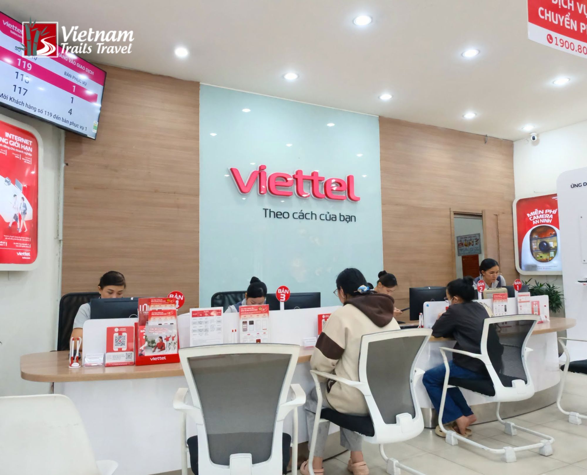 Tourists getting a Vietnam SIM Card for Tourist at a Viettel store where friendly staff guide them through activation