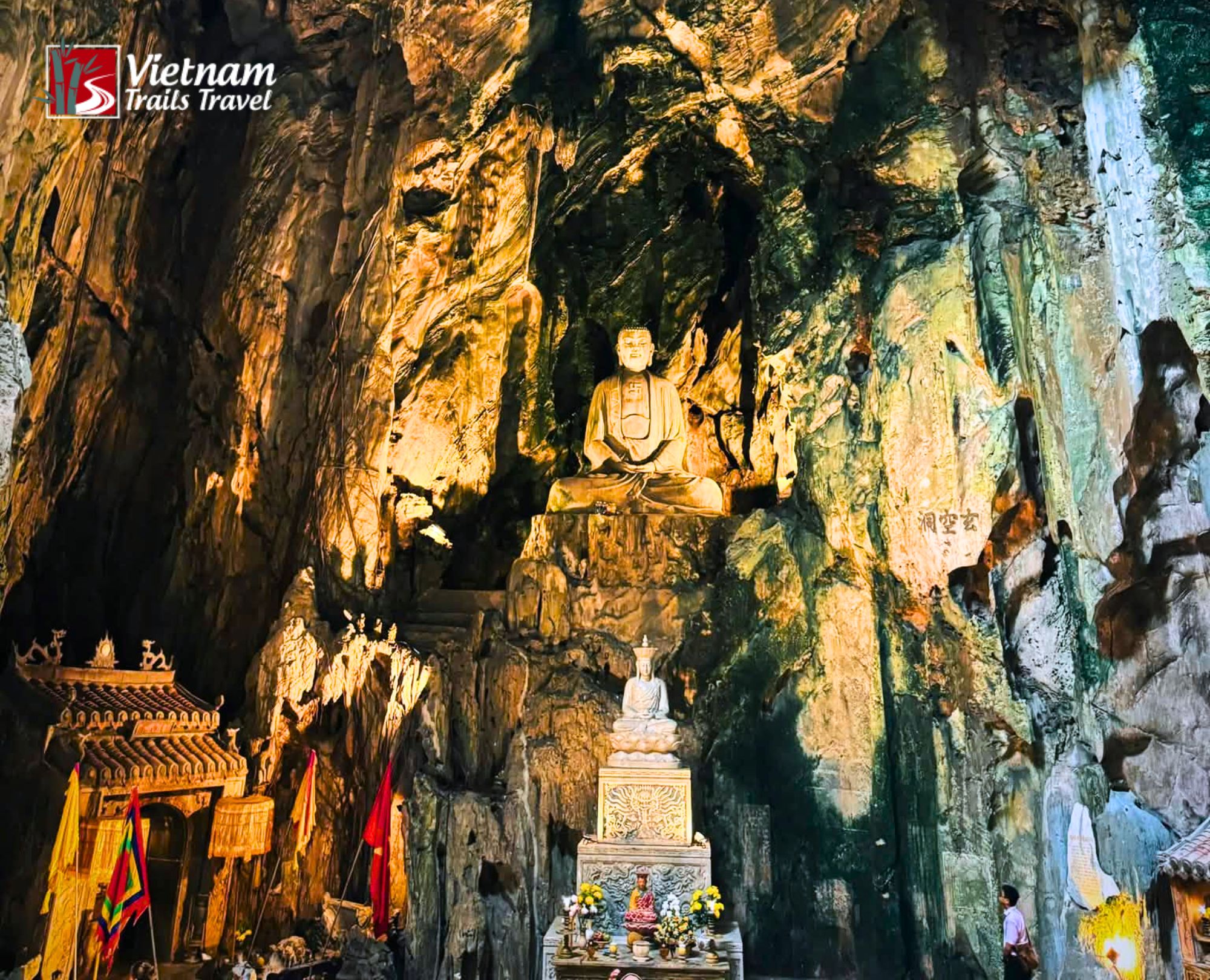 Atmospheric interior view of Huyen Khong Cave showcasing spiritual shrines and dramatic rock wallsAtmospheric interior view of Huyen Khong Cave showcasing spiritual shrines and dramatic rock walls