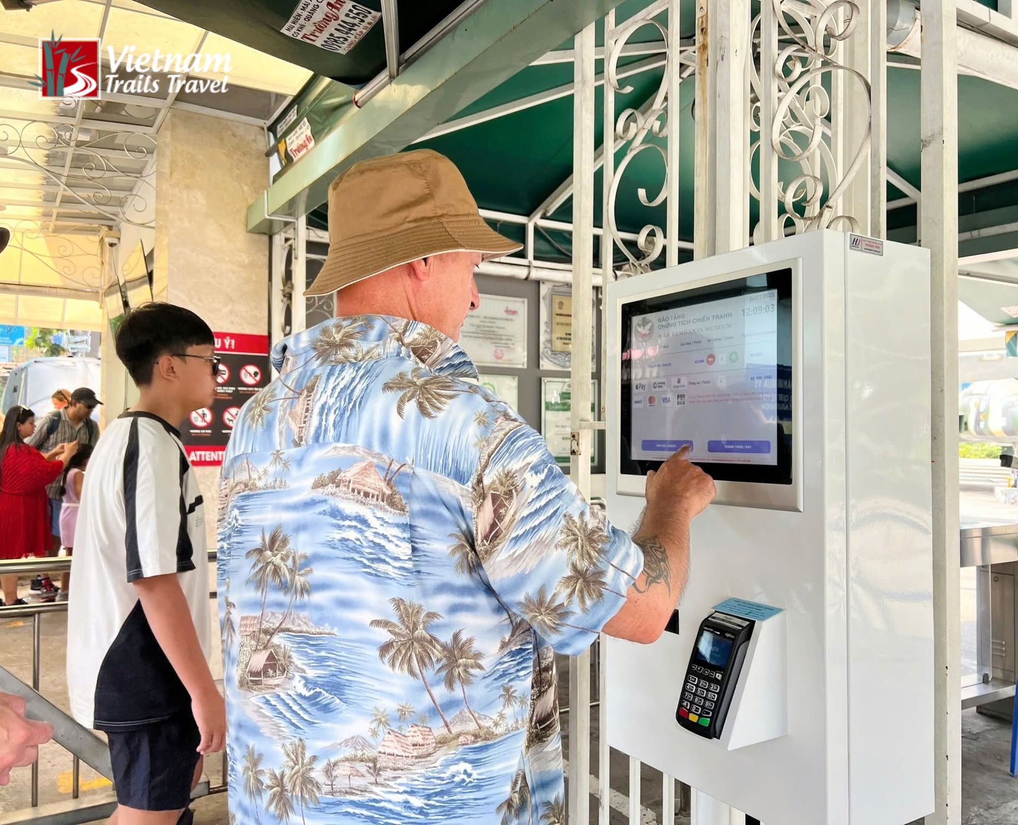 Foreign tourists purchasing admission tickets at the ticket counter of the War Remnants Museum