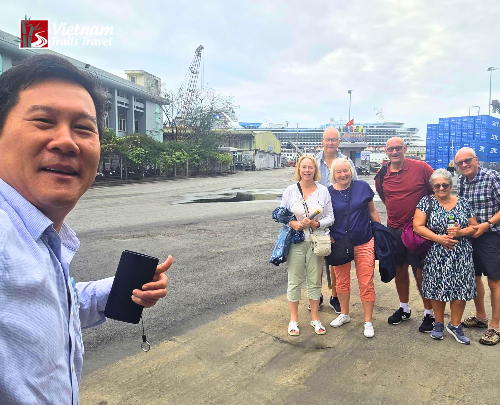 Friendly local guide meeting tourists outside the cruise port for a shore excursion
