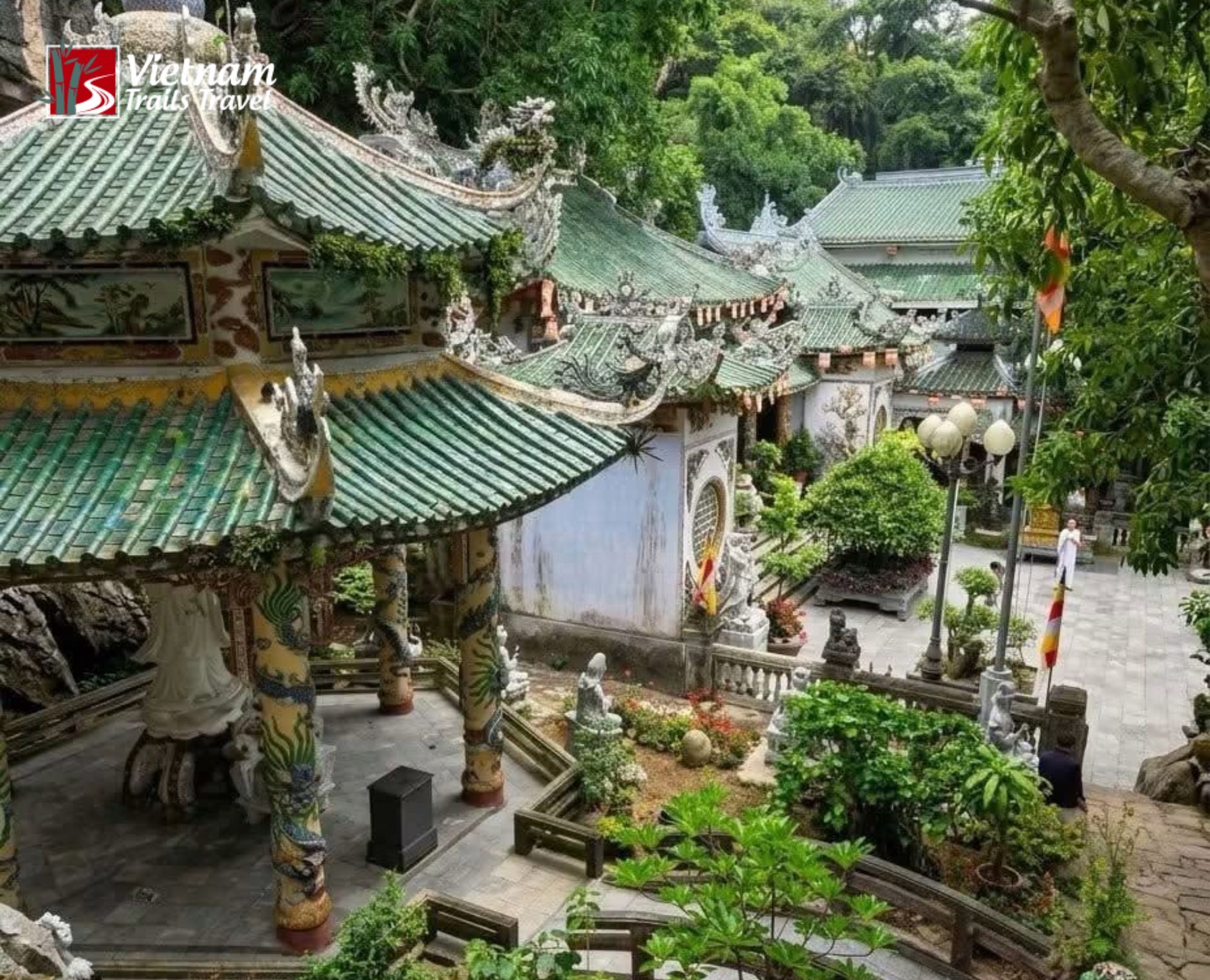 Traditional Buddhist architecture of Linh Ung Pagoda in Ngu Hanh Son, featuring dragon pillars and lush greenery