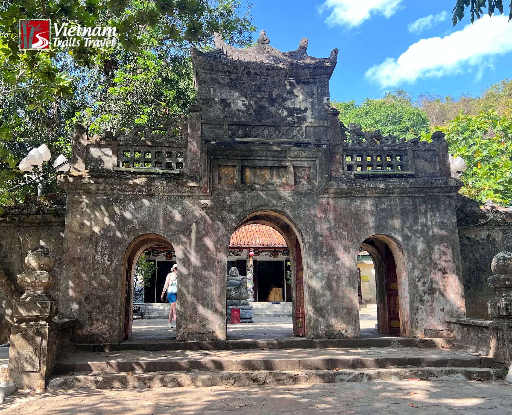 Traditional weathered stone gate structure at Tam Thai Pagoda, a renowned spiritual destination in Marble Mountain