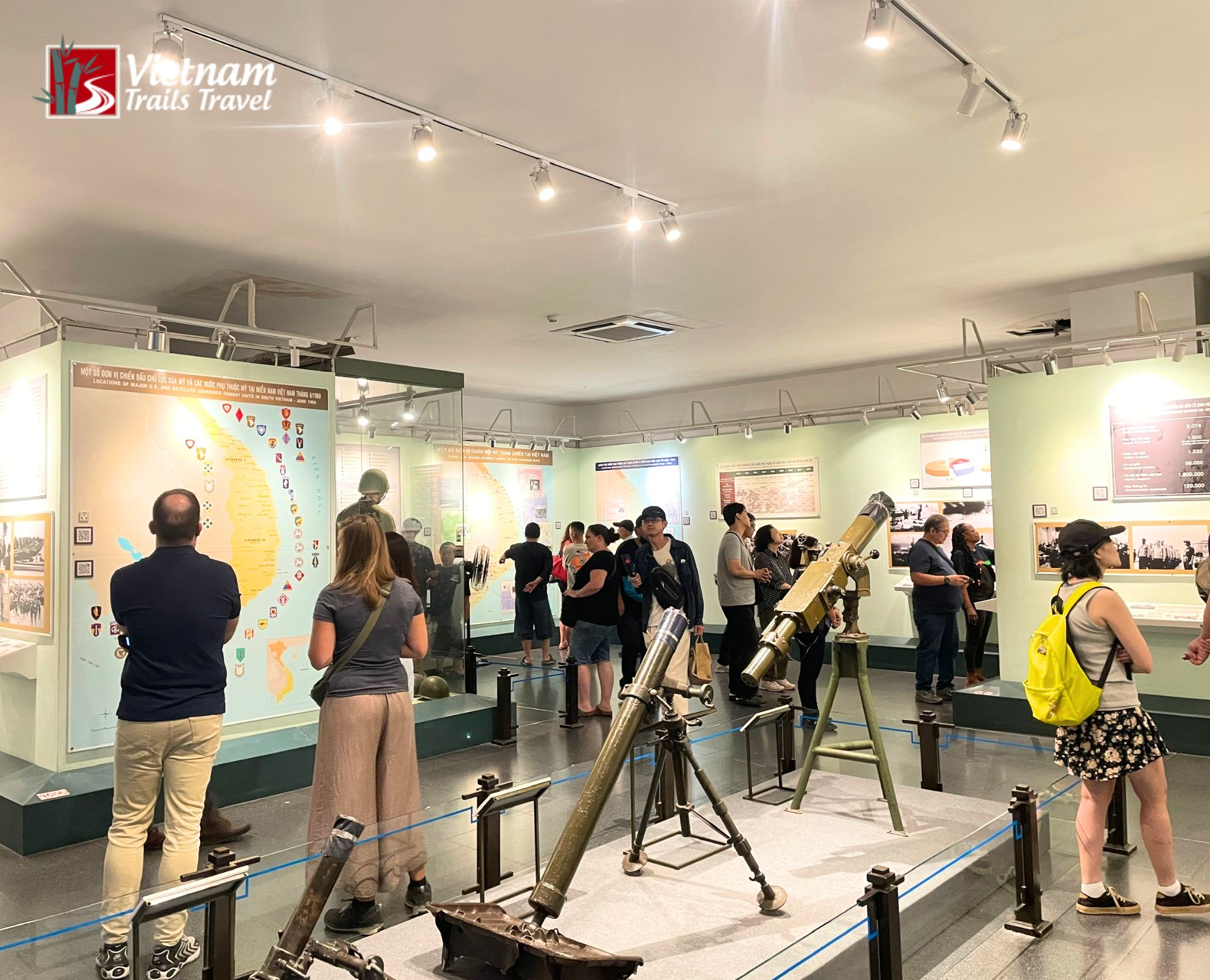 Visitors exploring historical artifacts and exhibits on the first floor of the War Remnants Museum
