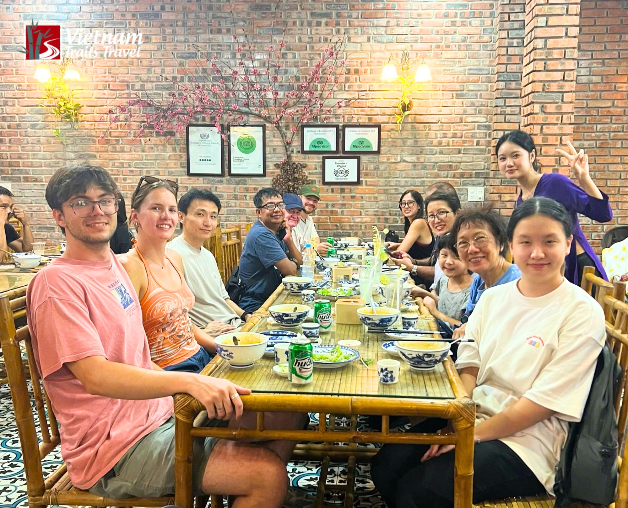 Visitors having traditional meal at local restaurant on Hue city tour from Chan May port