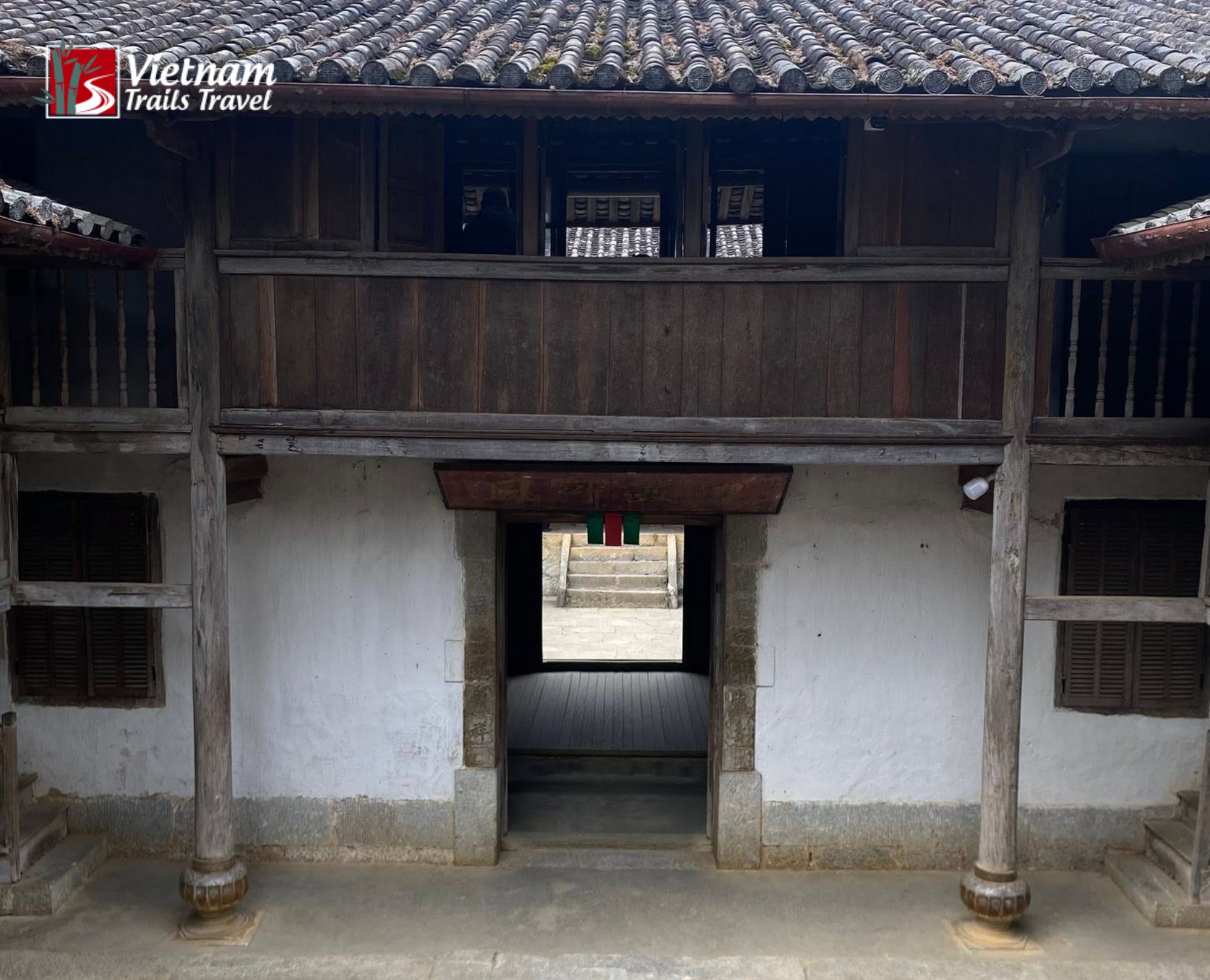 Dark tiled roofs and open wooden beams shape the upper floor of Vuong Palace in Ha Giang