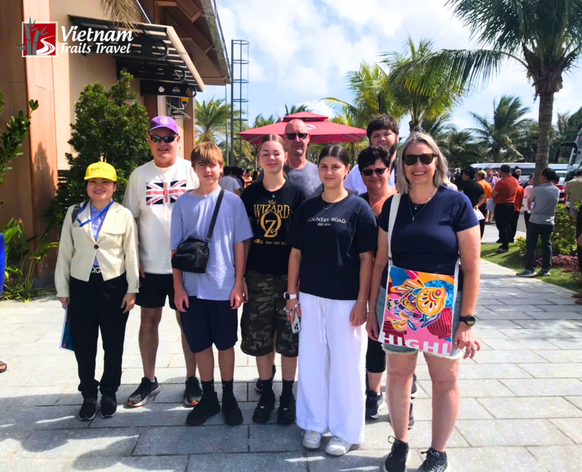 Group of adults and teenagers at the CaraWorld hotel entrance following a Nha Trang shore excursion pickup from Cam Ranh Port