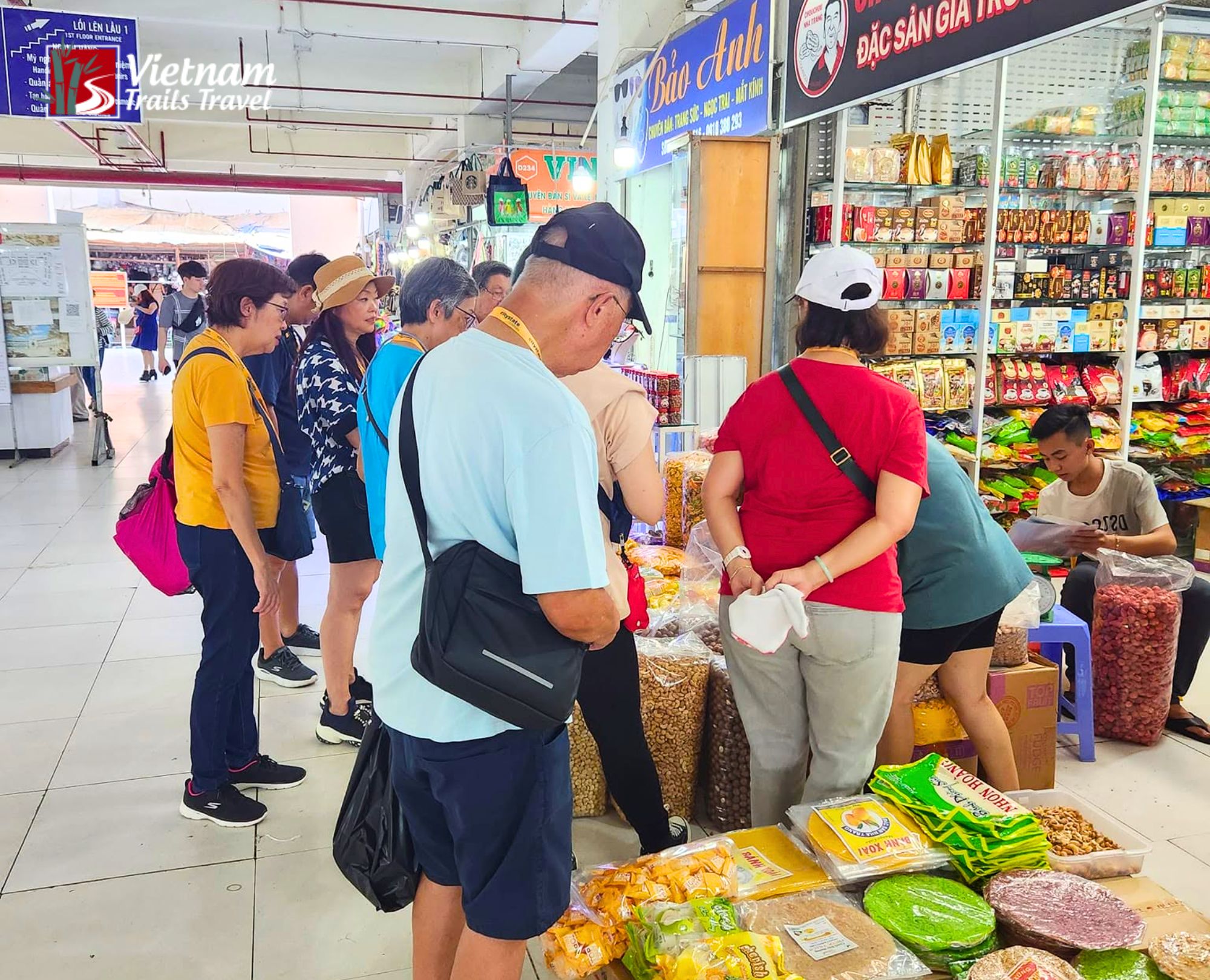 Group of visitors exploring the lively food stalls of Dam Market