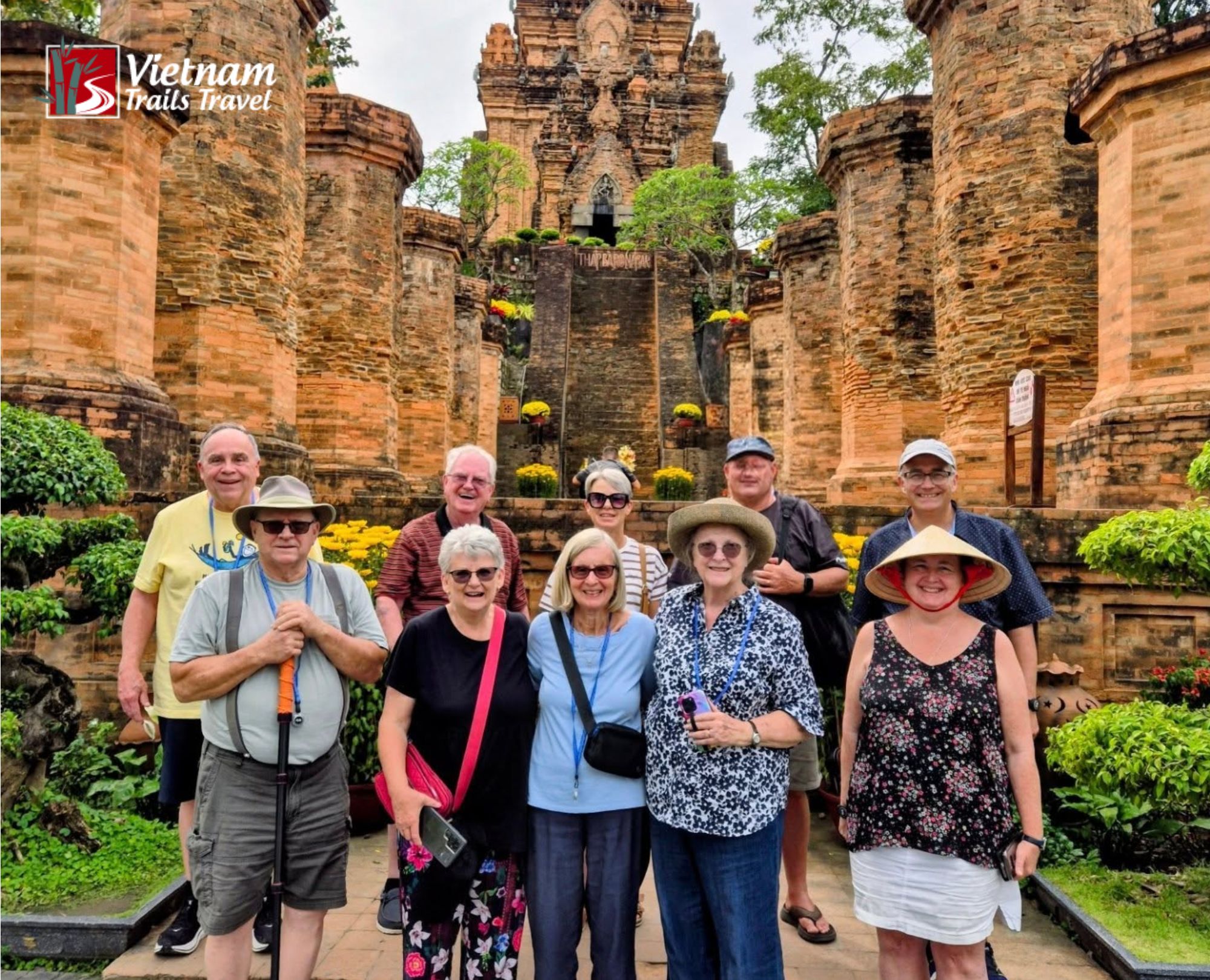 Group photo of older guests exploring the ancient Ponagar Tower temples