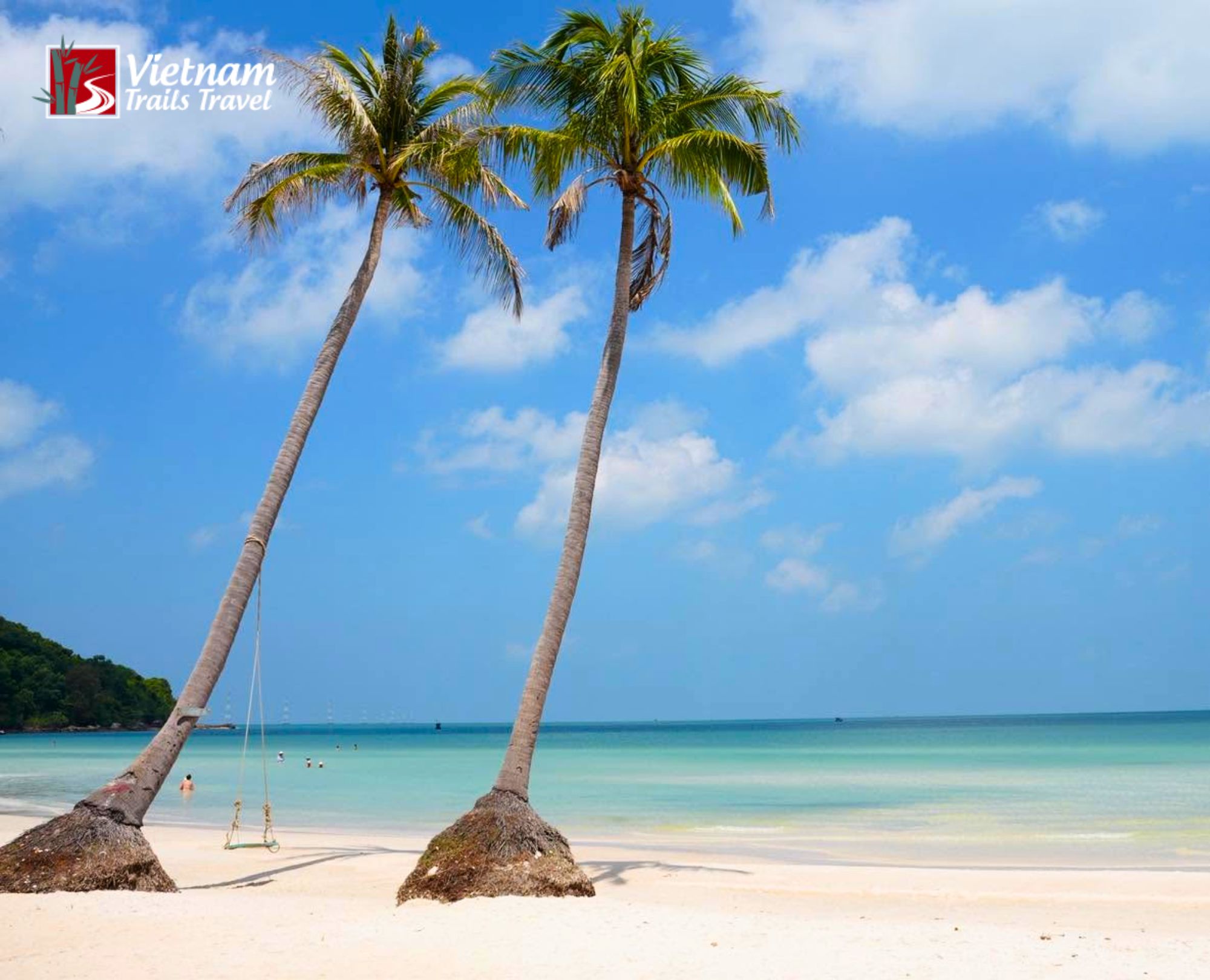 Iconic leaning coconut palms on the white sand and turquoise water of Sao Beach