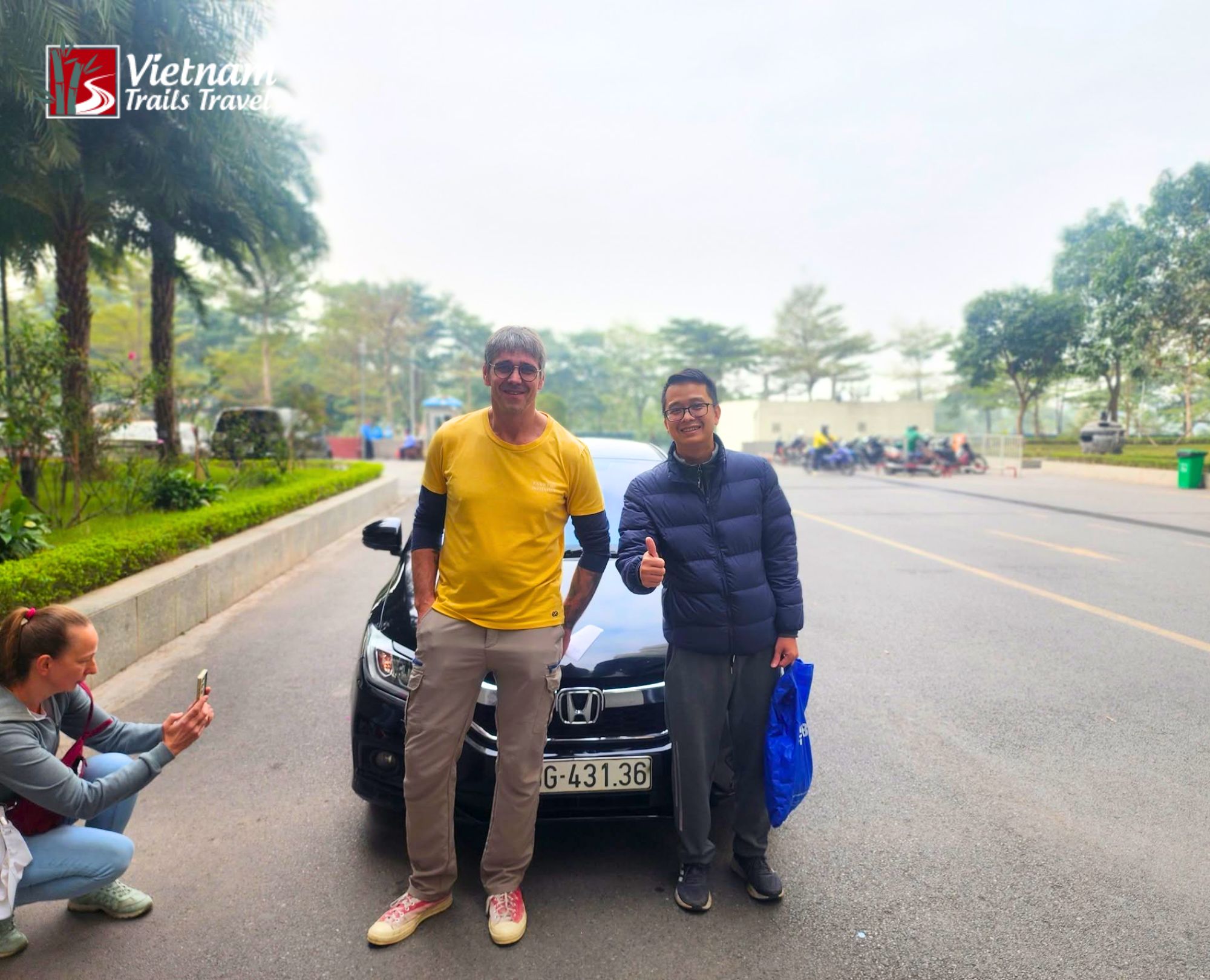 Self driving from Hanoi to Sung La Valley adventure with a group posing in front of their vehicle before driving on