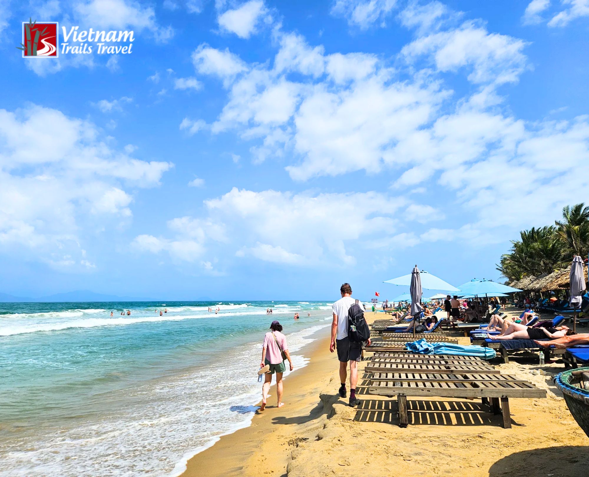 Tourists walking safely along the shoreline while following practical coastal safety guidelines