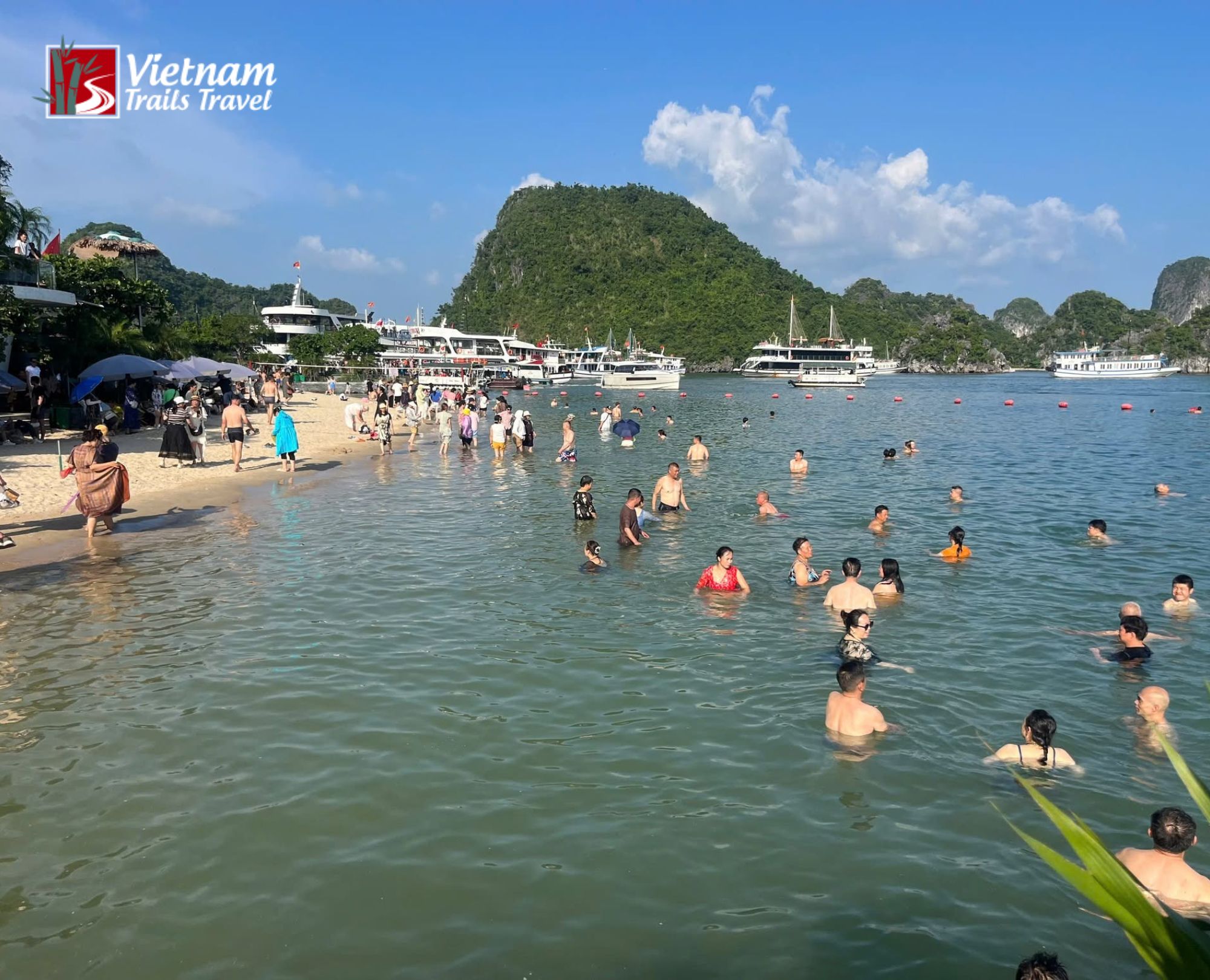 Travelers swimming and relaxing on Titov Island beach in Halong Bay Vietnam