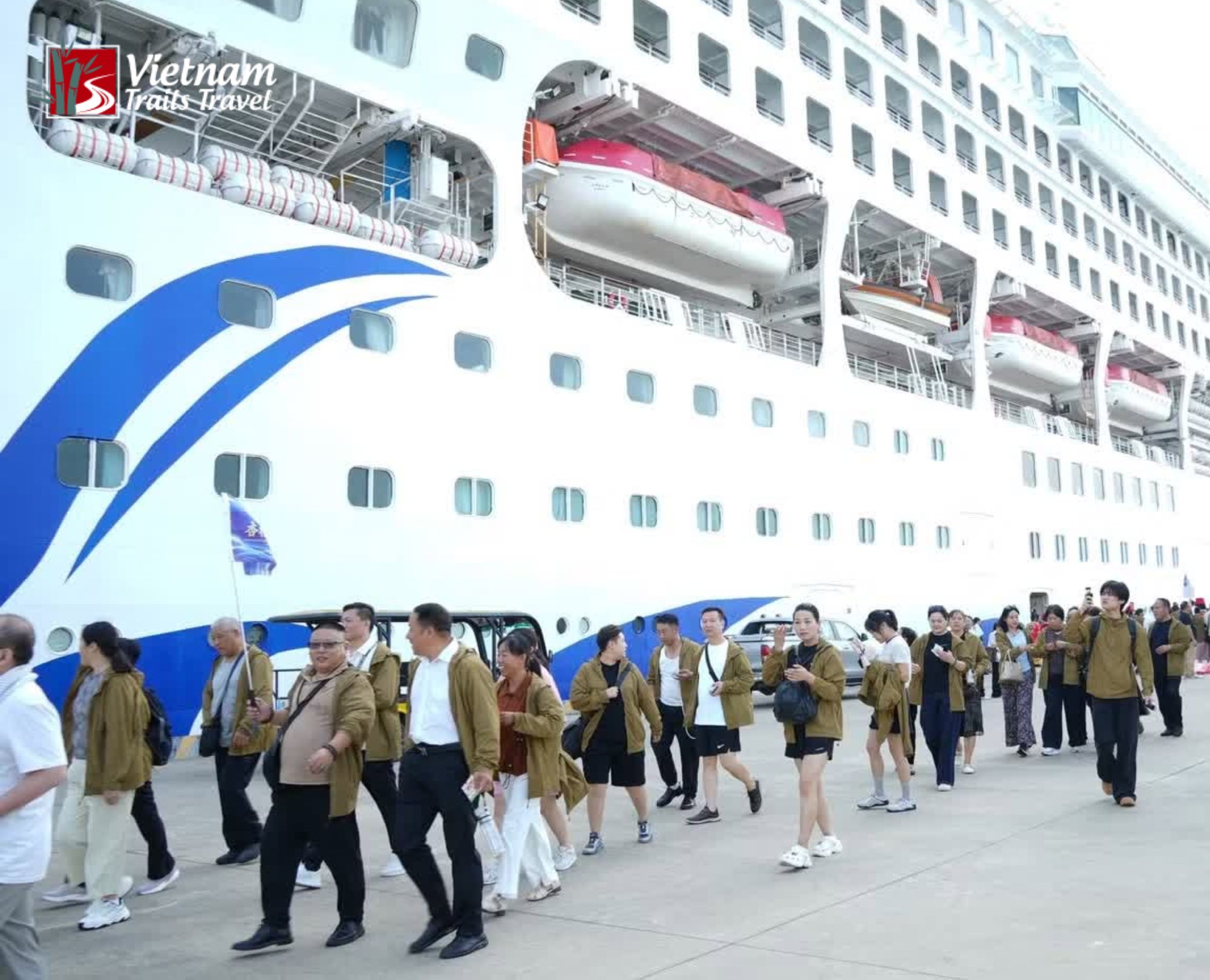 Vietnam Trails Travels guests disembarking beside a white cruise ship at Halong port