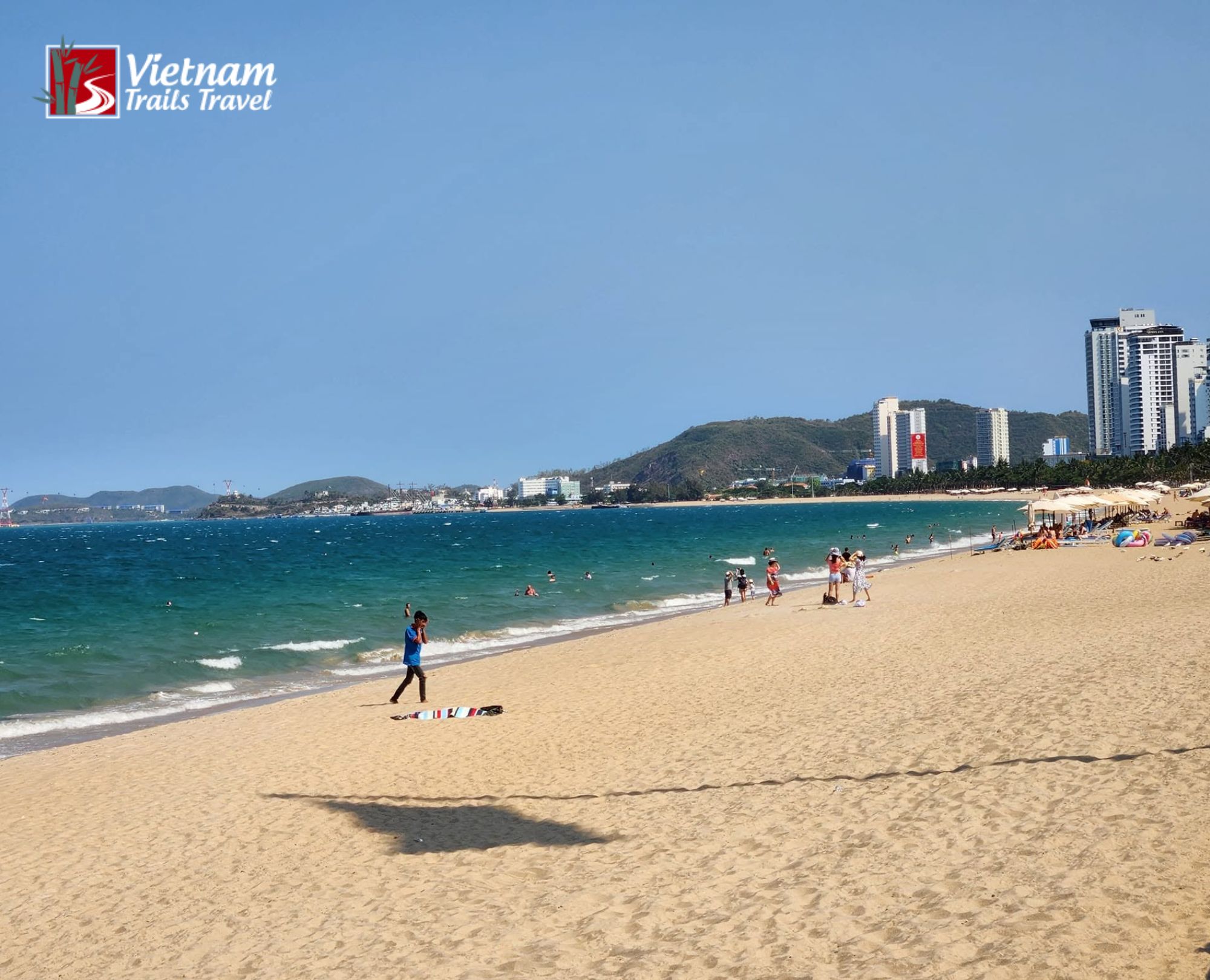Wide sandy beach and clear blue sea at Tran Phu Beach