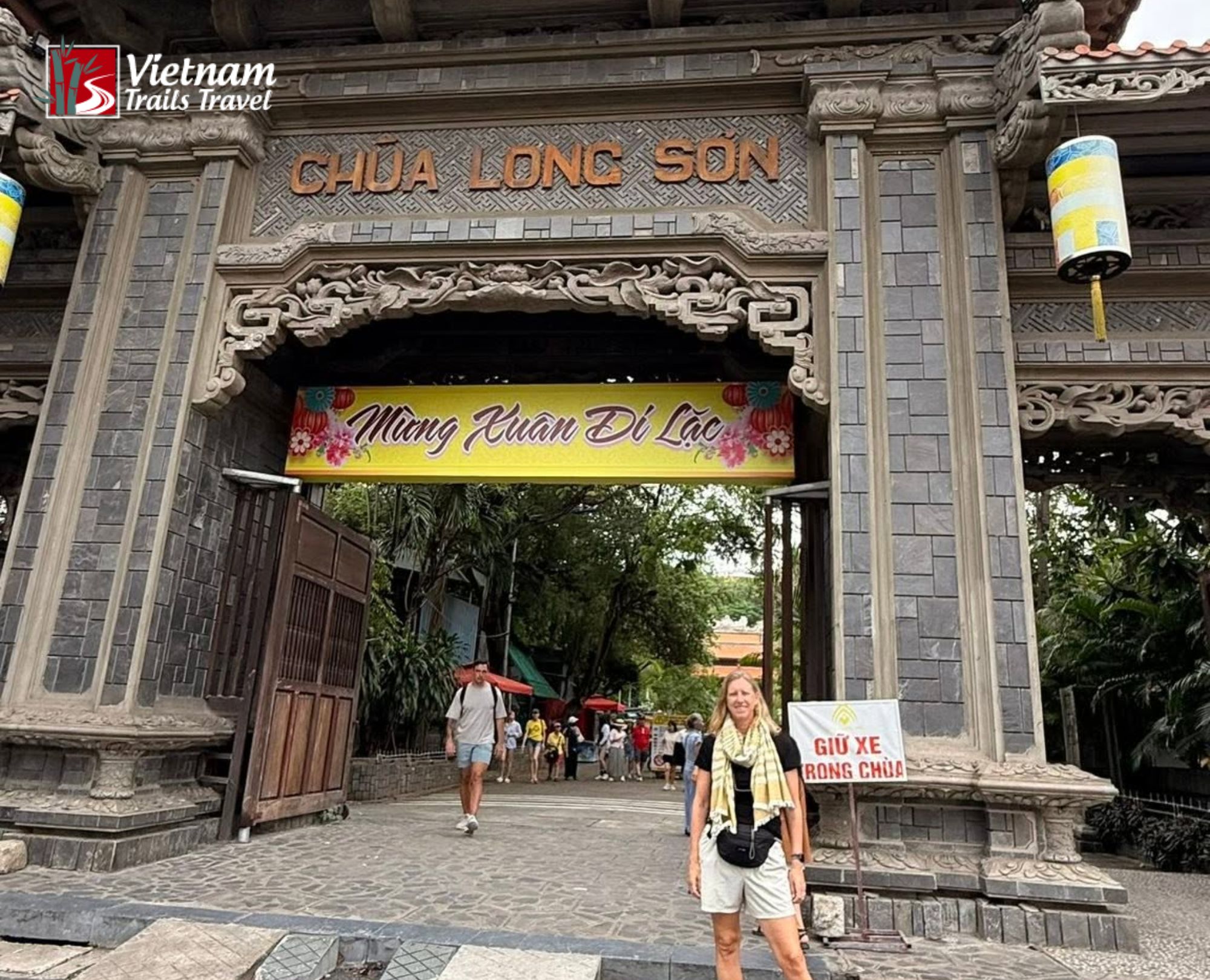 Woman posing at the entrance of Long Son Pagoda